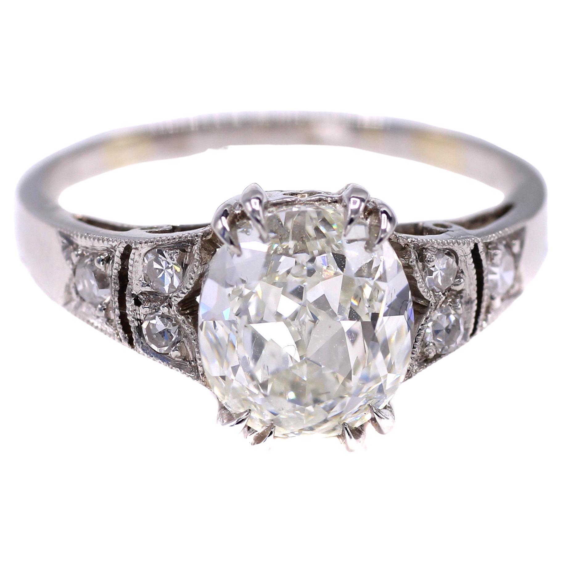 A beautiful and lively Cushion Brilliant is the centerpiece of this beautiful and well handcrafted platinum engagement ring. The cushion is accompanied by a report from the GIA giving it a color grade of K and a clarity of SI1. The amazing cut of