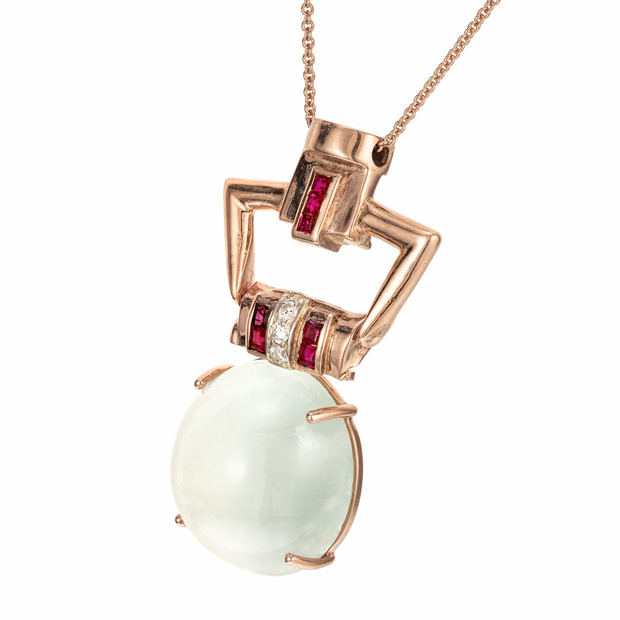 Retro Art Deco Cats Eye Aqua, diamond and ruby pendant necklace. 20.50 cabochon natural cats eye Aqua with a 14k rose gold bail, accented with 3 transitional cut diamonds and 7 square cut rubies.  16 inch rose gold chain. Circa 1935 – 1940.

1 light