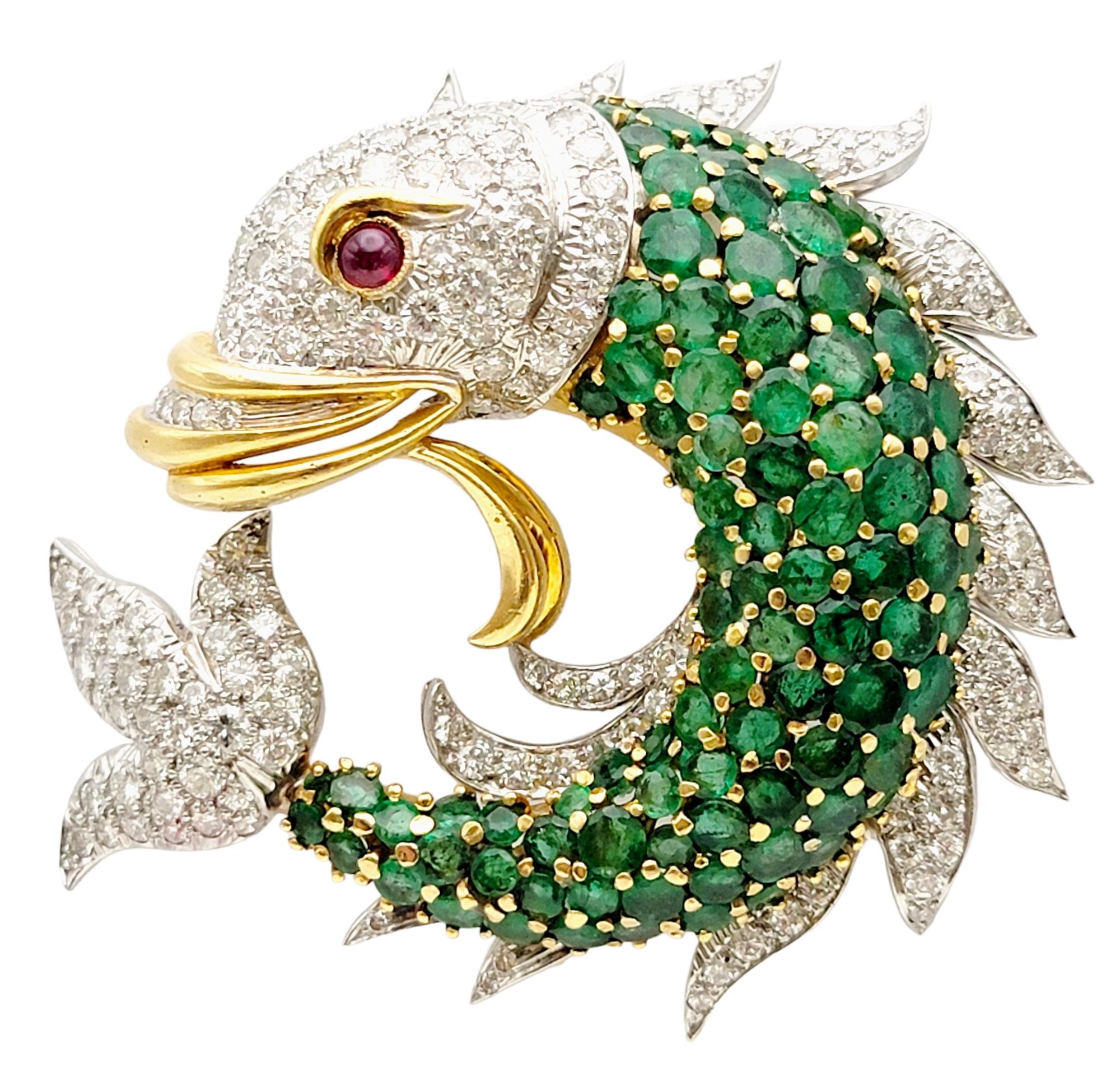 Step into a undersea world of enchantment with this extraordinary fish brooch, a magnificent blend of emeralds, diamonds, and rubies meticulously crafted in 18 karat gold. Exuding elegance and whimsy, this one-of-a-kind piece captures the essence of