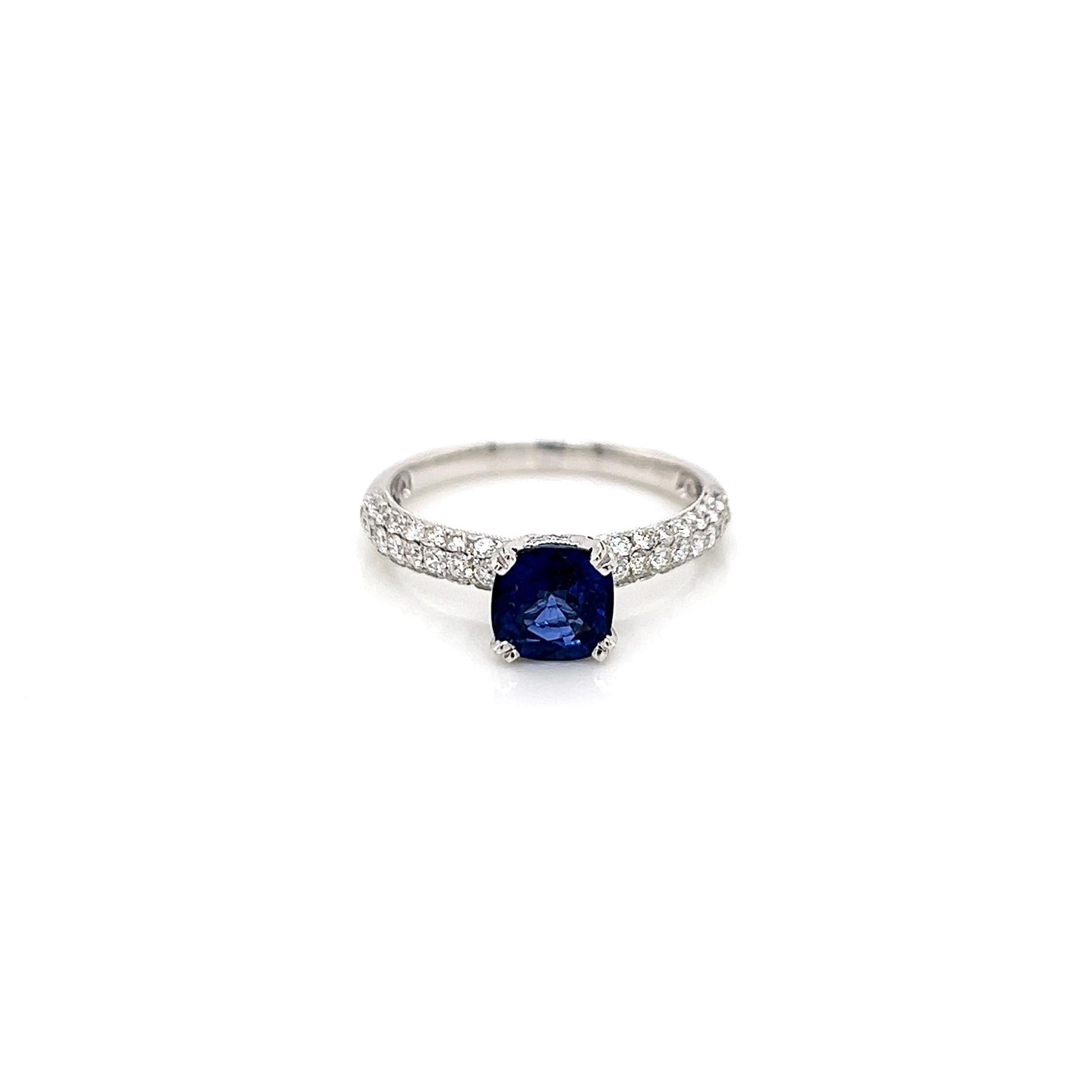 2.05 Total Carat Sapphire Diamond Engagement Ring

-Metal Type: 18K White Gold
-1.25 Carat Cushion Shaped Blue Sapphire
-0.80 Carat Round Side Diamonds 
-Size 7.0
Resizable for an additional fee.

Made in New York City.