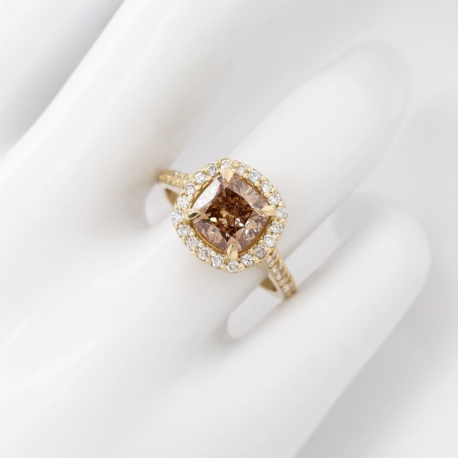 In this elegant and classy 14kt Yellow gold ring, 2.05 carat fancy yellowish brown diamond ring is surrounded by 34 natural round brilliant diamonds totaling 0.51 carats round brilliant diamonds and creating a very gentle and sparkly