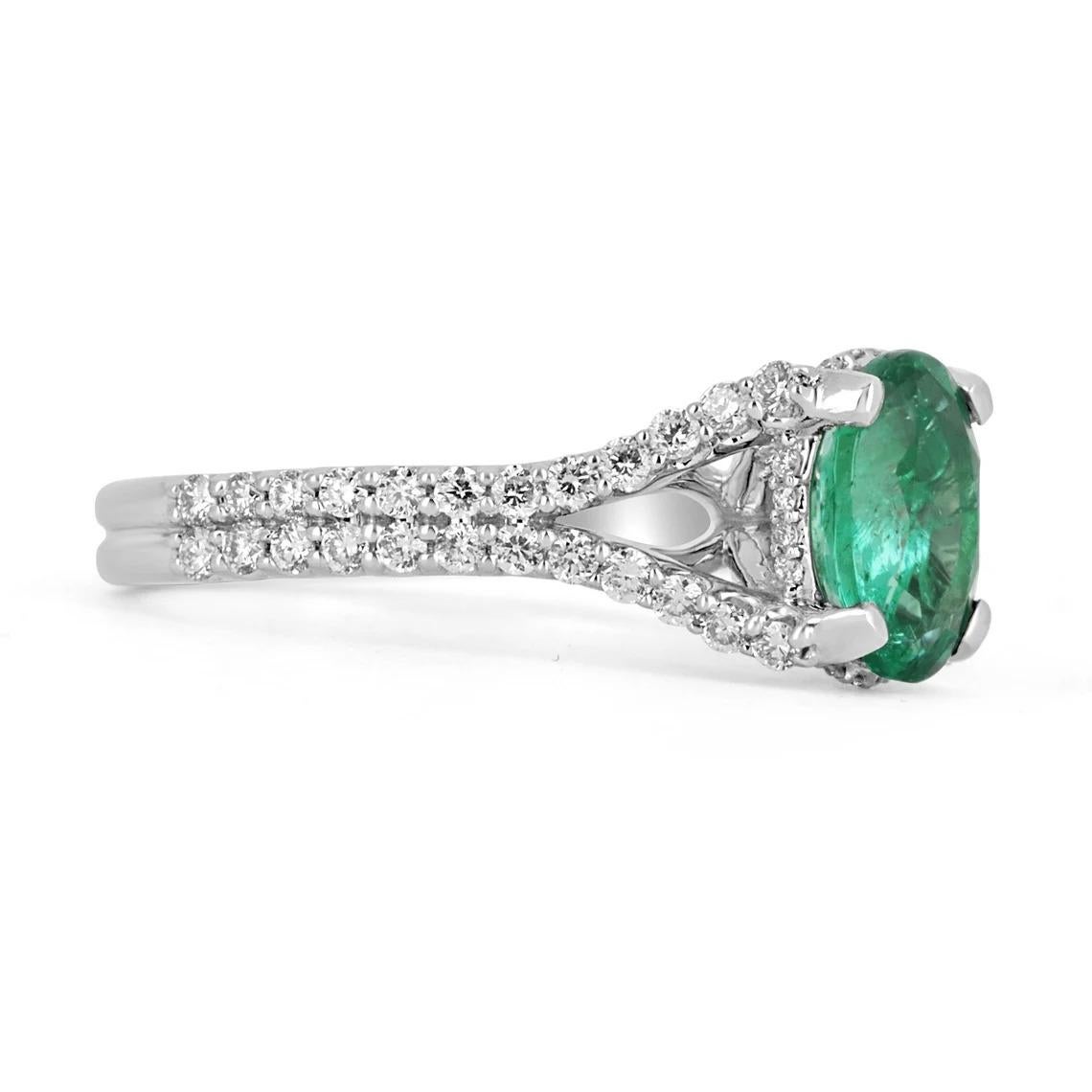 This is an exquisite, Colombian emerald and diamond halo split shank ring. The gorgeous setting lets sit an excellent quality Colombian emerald with beautiful color and very good eye clarity. The emerald is not perfect and small imperfections do