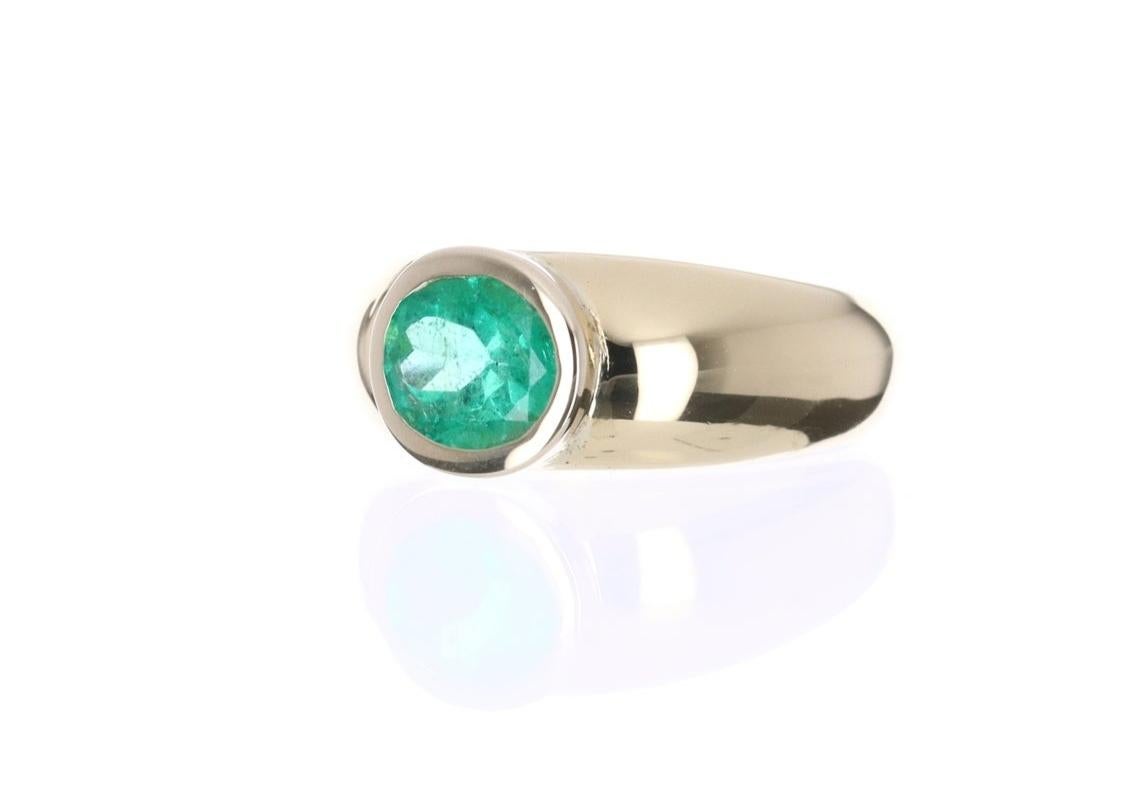 Displayed is a magnificent 2.05tcw natural Colombian emerald cocktail ring. This high fashion piece exhibits one gorgeous center stone. A fine quality, Colombian emeralds is handset in an 18K yellow gold bezel setting. The gemstone has an intense