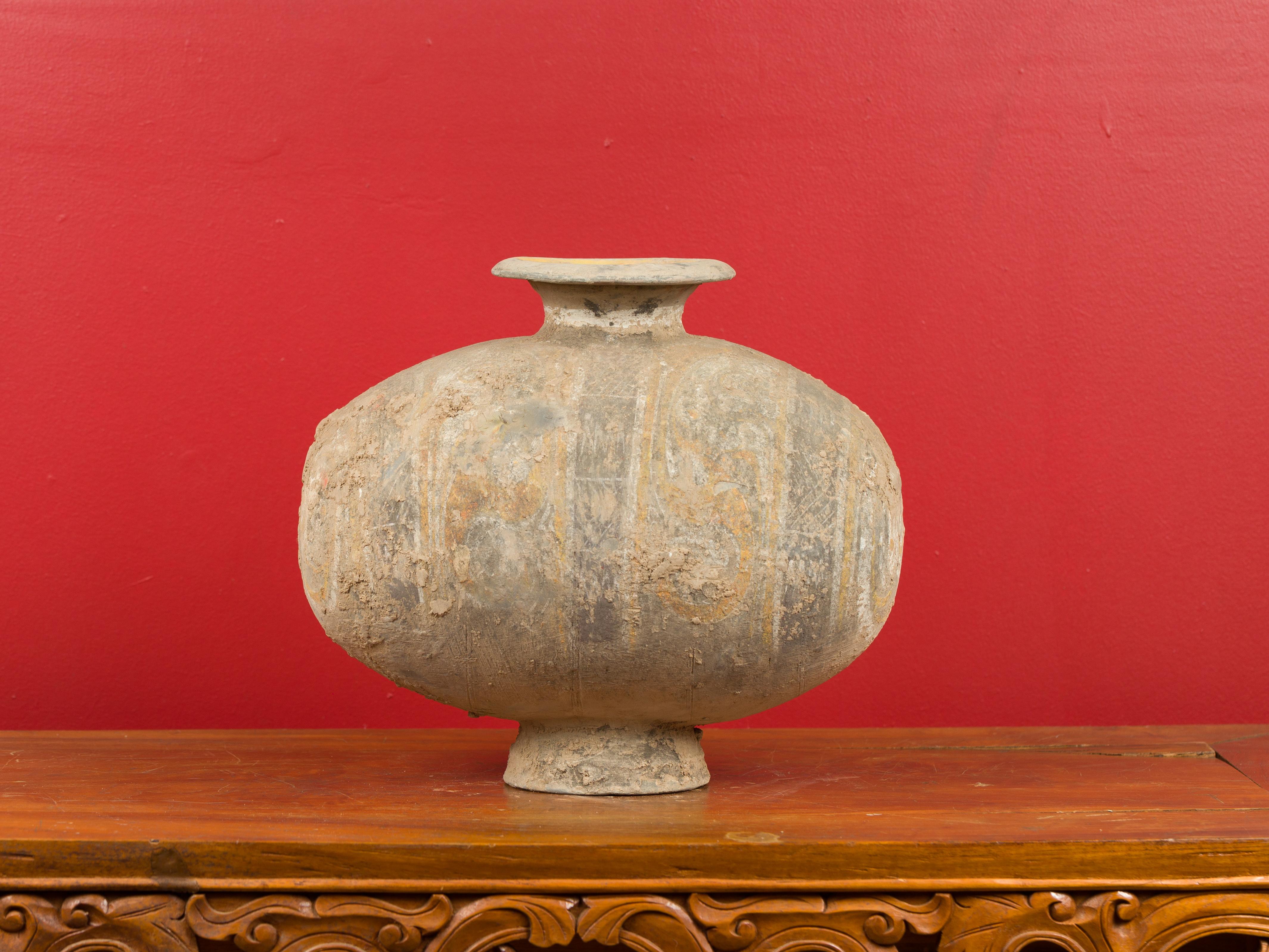 A Chinese Han Dynasty terracotta silk cocoon jar circa 206 BC-220 AD with original hand-painted décor and nicely weathered patina with deposits on the surface. Born in China, this antique jar adopts a silk cocoon shape, relating to the silk industry