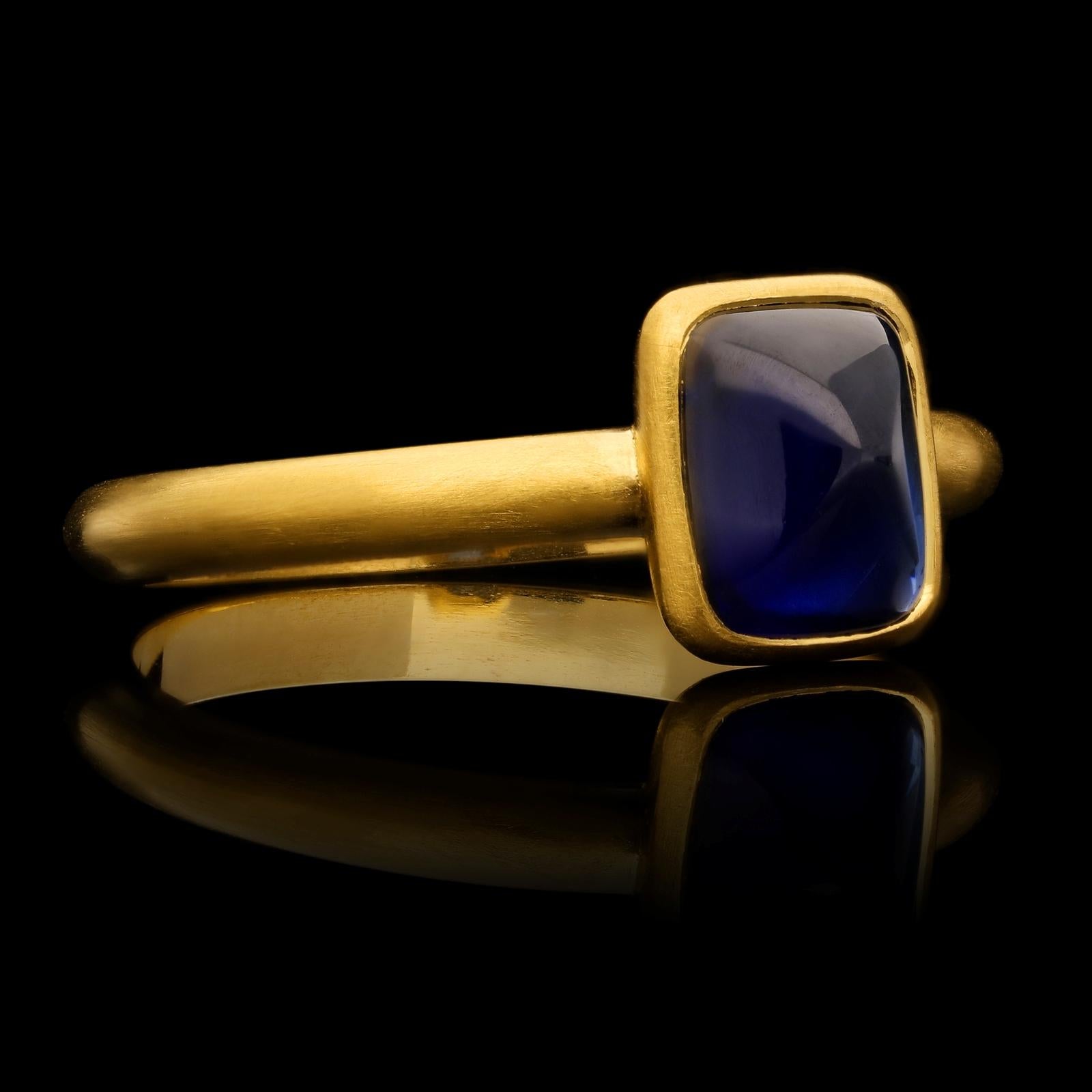 A contemporary Burmese sapphire and gold ring by Hancocks, set with a cushion shaped sugar loaf unheated Burma sapphire of rich blue colour weighing 2.06ct, rubover set in a finely crafted handmade 22ct yellow gold mount with beautiful satin finish