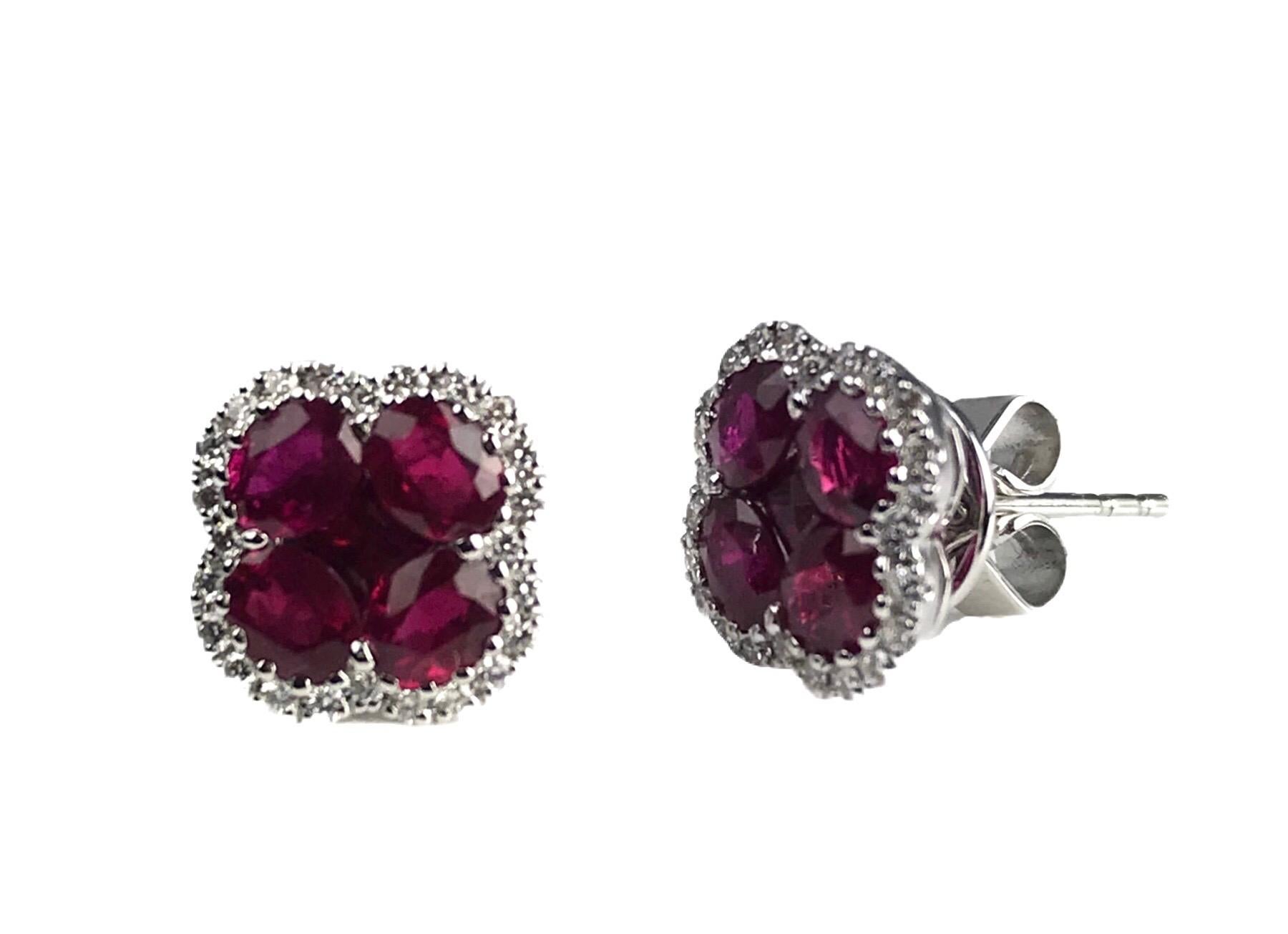 Elevate your jewelry collection with these exquisite earrings that radiate elegance and sophistication. Featuring four oval and one princess-cut rubies, these earrings are a true symbol of timeless beauty. The rubies are encircled by a dazzling halo