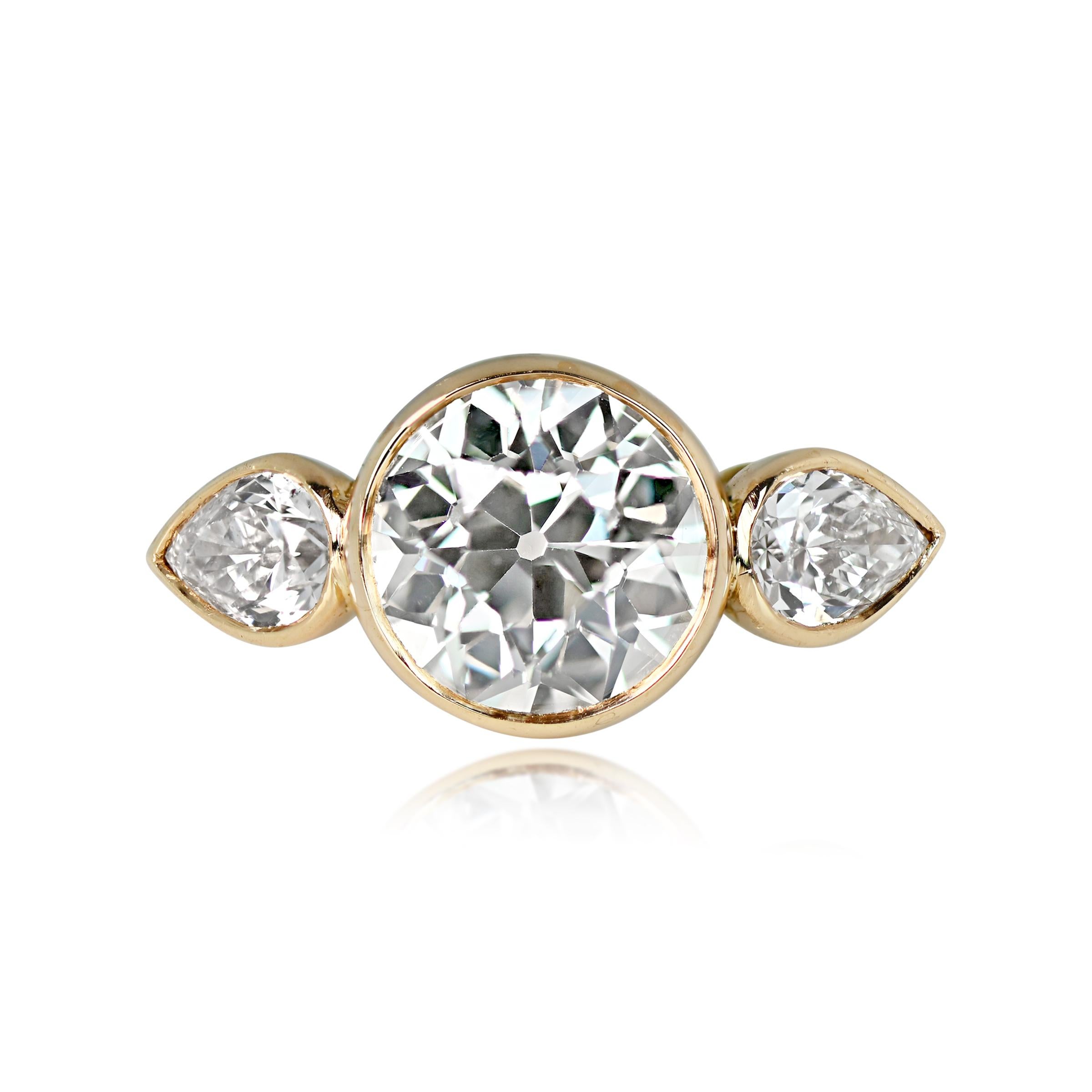 This elegant handmade diamond ring is set in 18k yellow gold, featuring a lively old European cut diamond bezel-set at the center, flanked by two pear-shape diamonds. The center diamond is a stunning 2.06 carats in J color and VS2 clarity, while the