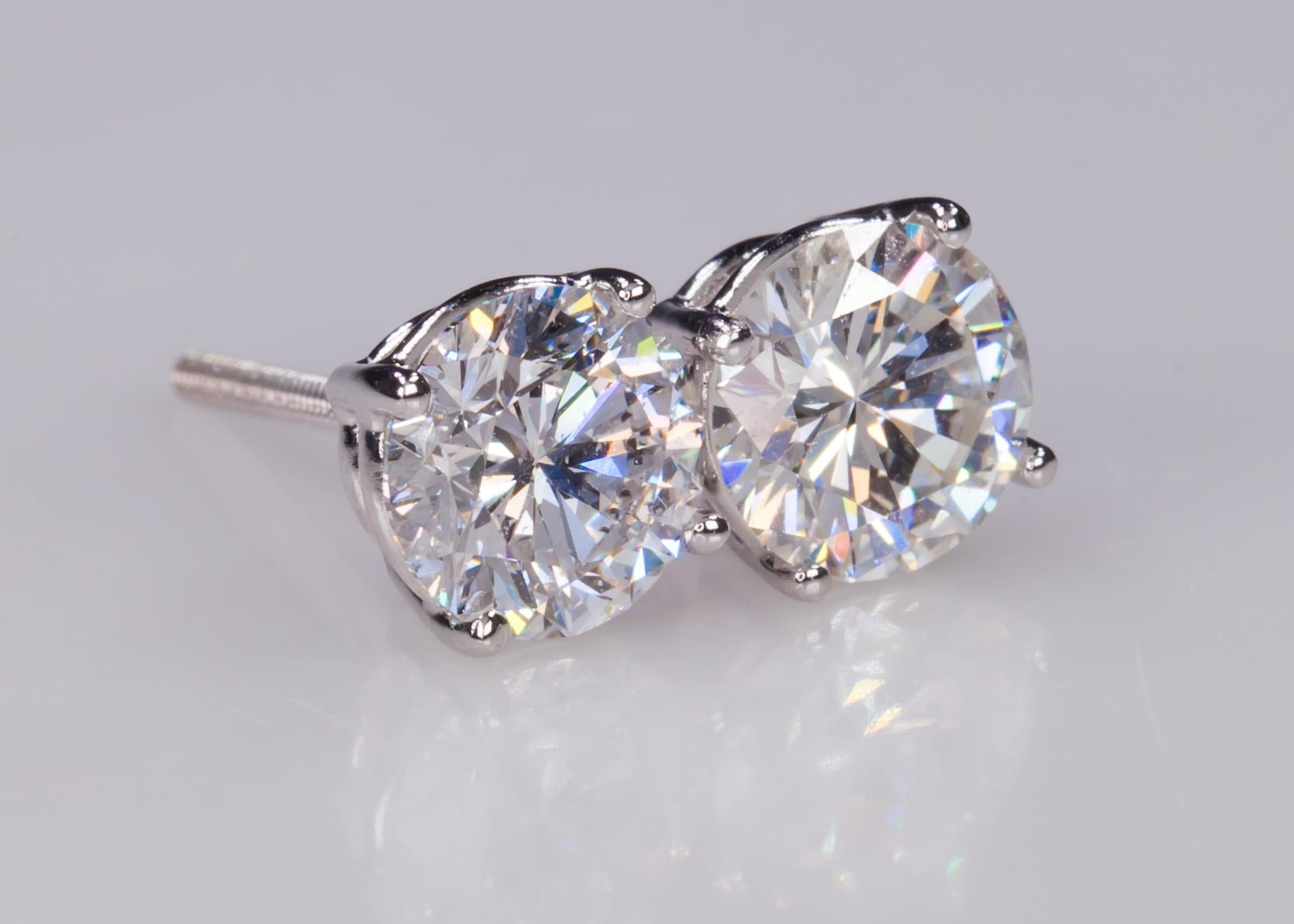 Beautiful Round Diamond Stud Earrings
Four-Prong Settings in 14k White Gold
Total Carat Weight = 2.06 Cts
Color: G - H
Clarity: SI1
Dimensions of Stones:
6.31mm x 4.03mm 
6.53mm x 3.97mm
Total Mass = 1.7 grams
Gorgeous Pieces!