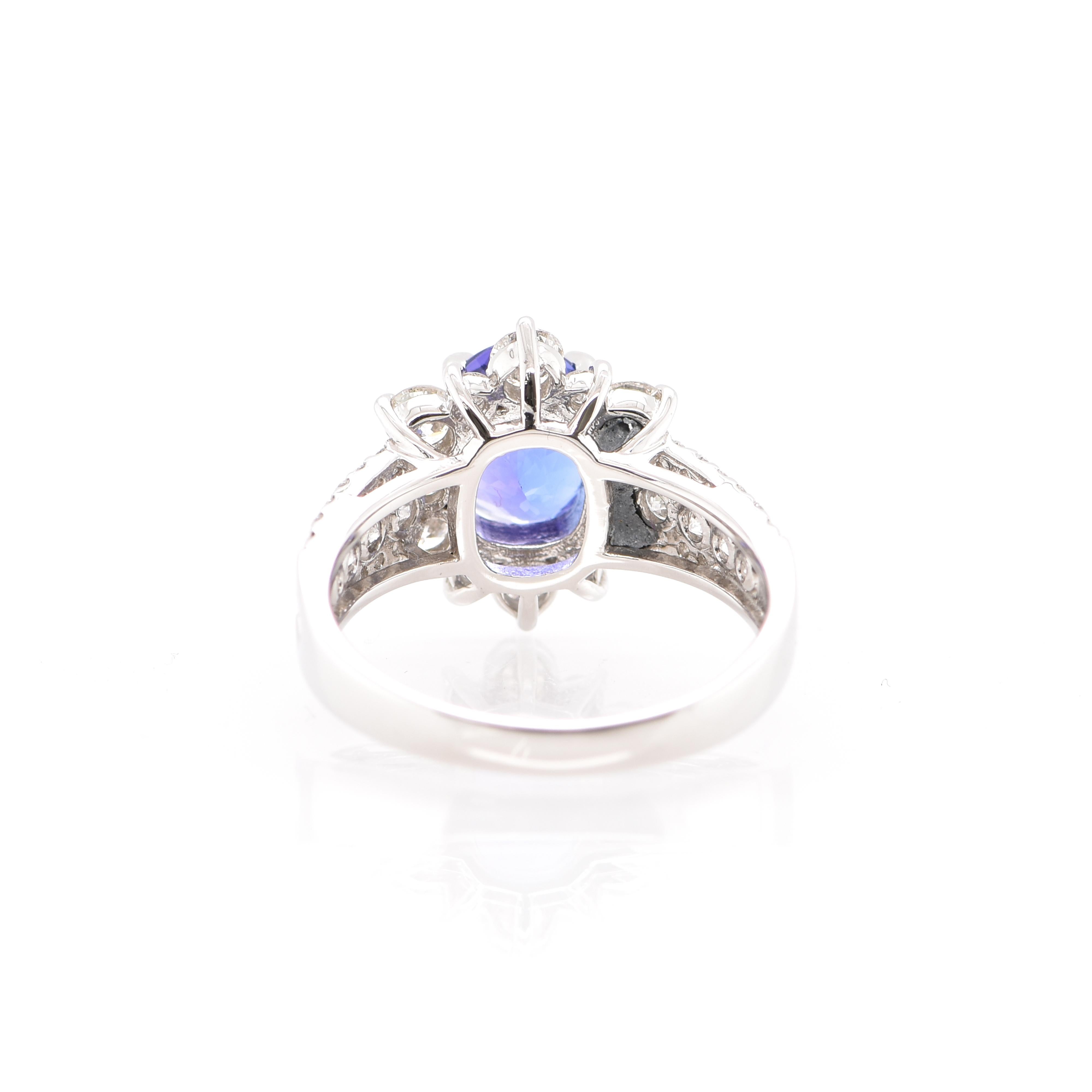 A beautiful Halo Ring featuring a 2.06 Carat Tanzanite and 1.24 Carats of Diamond Accents set in Platinum. Tanzanite's name was given by Tiffany and Co after its only known source: Tanzania. Tanzanite displays beautiful pleochroic colors meaning