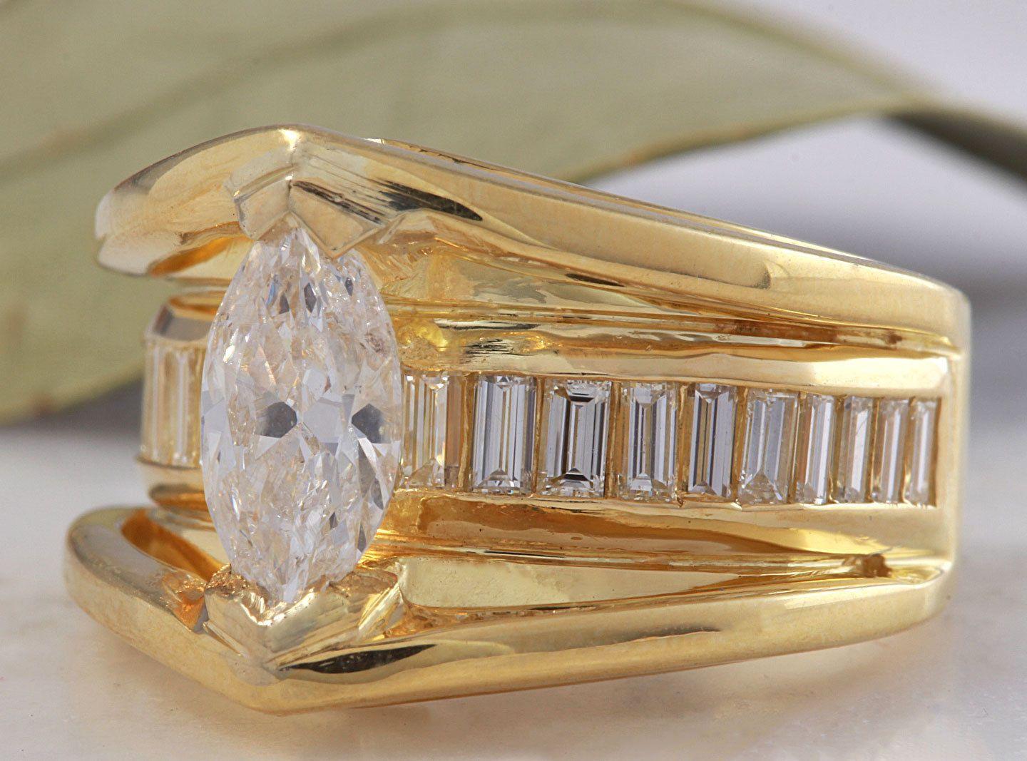 2.06 Carats Natural Diamond 18K Solid Yellow Gold Engagement Ring

Center Marquise Diamond Weight is: 1.06 carats (SI3 / F)

Baguette Diamonds Weight is: 1.00 carat (VS1 / F)

The width of the ring is: 14mm

Ring size: 6.5 (we offer free re-sizing