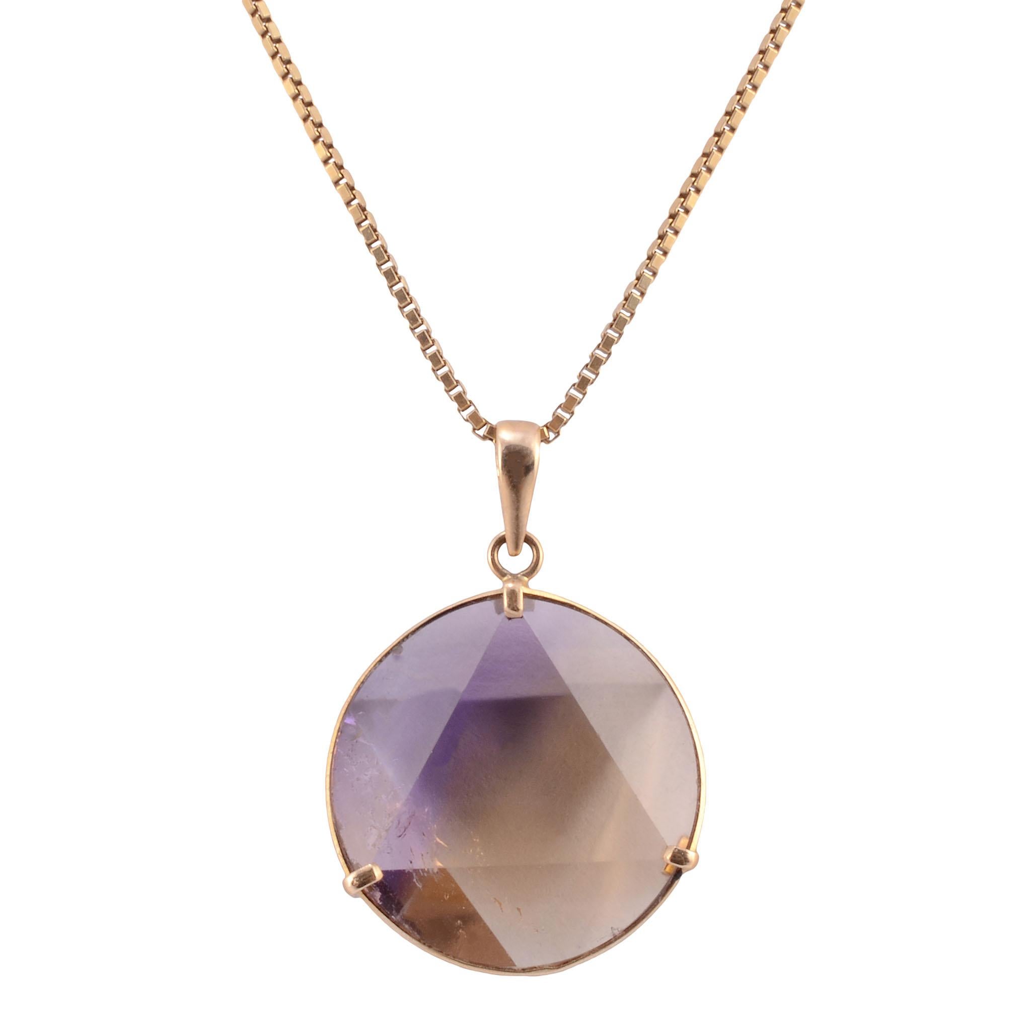 Vintage 20.67 carat ametrine 18K pendant on chain, circa 1960. This 18 karat yellow gold pendant features a round faceted ametrine at 20.67 carats. [MICO 800]

Dimensions
20mm Diameter ametrine; 20″L chain