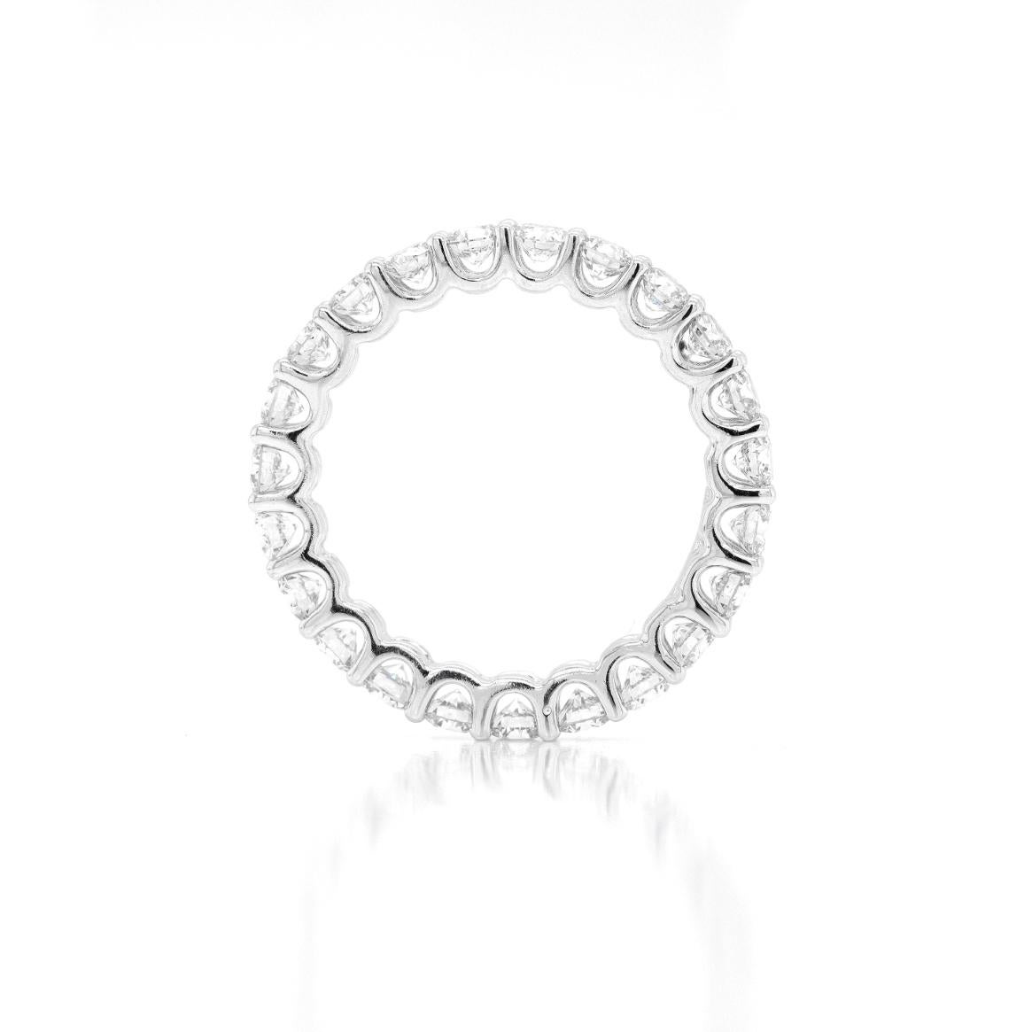 This exquisite full eternity ring is beautifully claw set with 23 fine quality round brilliant cut diamonds, weighing 2.06 carats combined, all mounted in 18 carat white gold open back settings. Stamped D2068, K18. UK finger size 'L'.