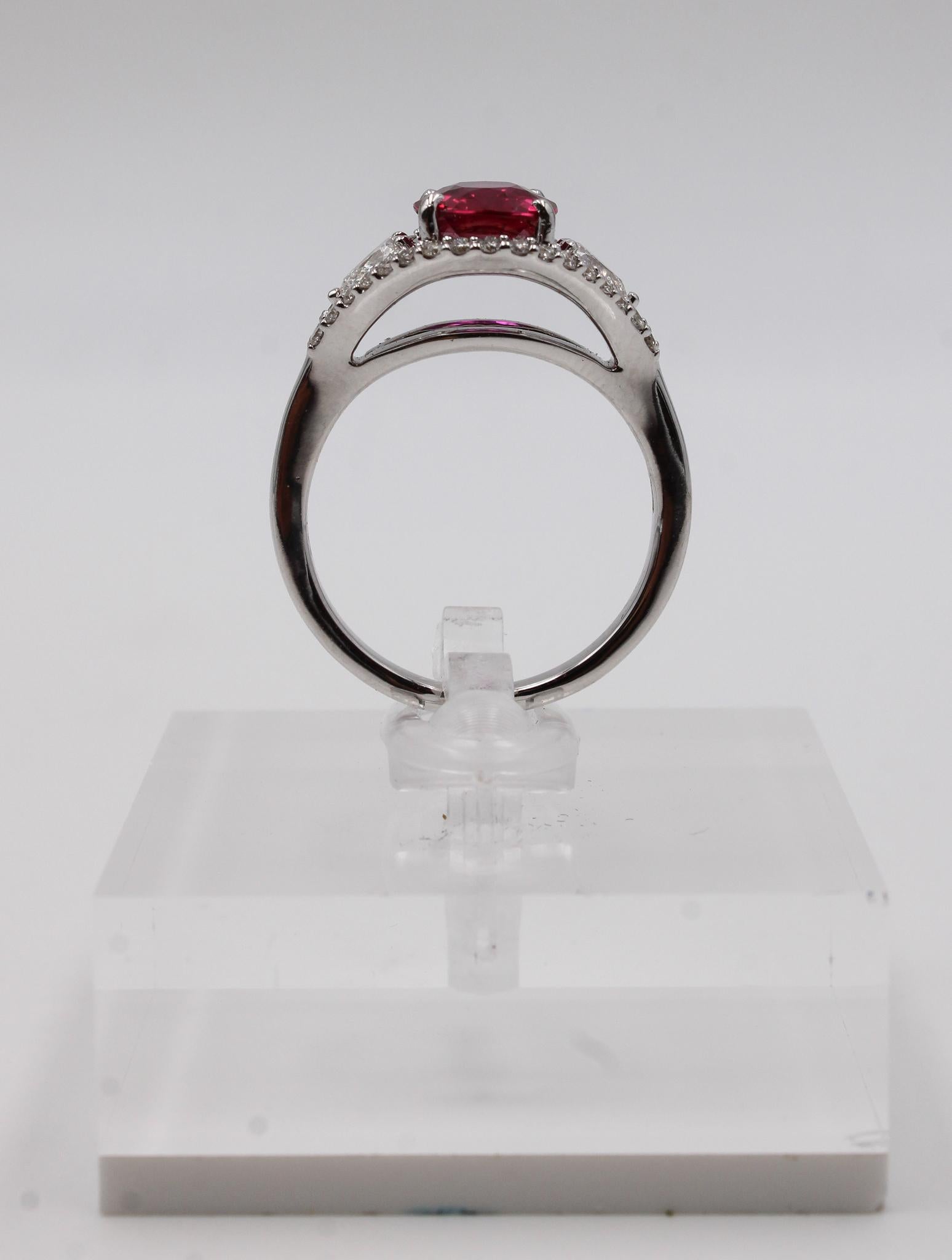 This elegant ring features a certified 2.06-carat natural ruby of Mozambican origin, boasting an intense, vivid red hue and exceptional brilliance. The ruby, expertly cut in an oval brilliant/step style, is confirmed unheated by GRS, a highly