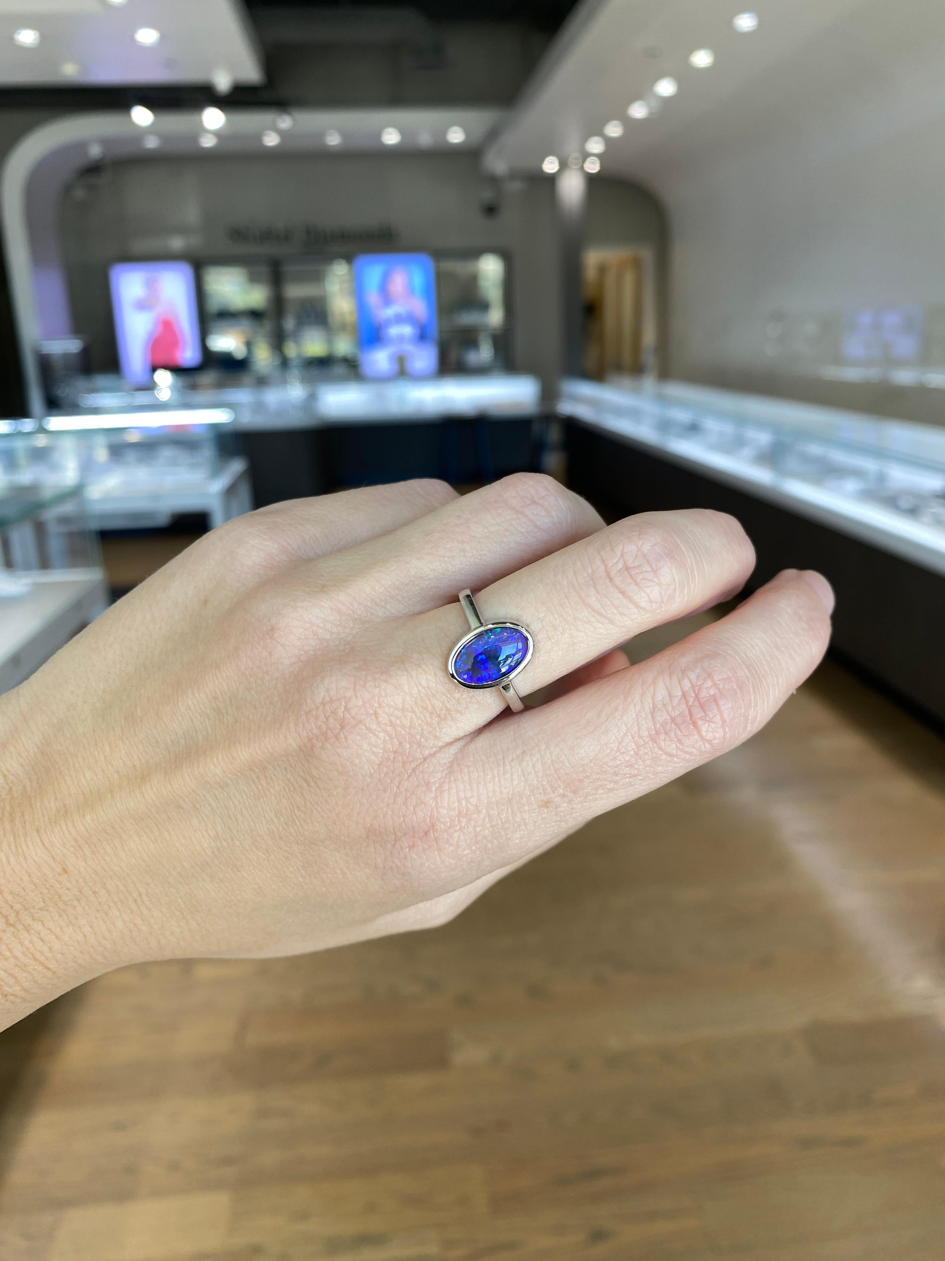 2.07 Carat Blue Oval Opal Bezel Set 18 Karat Gold Ring For Sale 5
