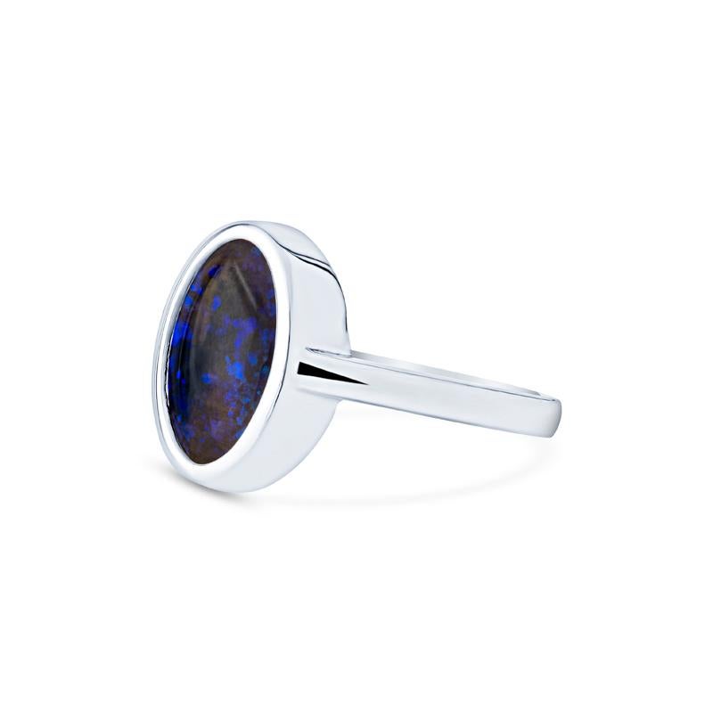 This elegant ring features a mesmerizing 2.07 carat blue oval opal bezel set in 18 karat white gold. Perfect to wear daily or for adding a touch of sophistication to any outfit. It is a size 6.5 but can be resized upon request.