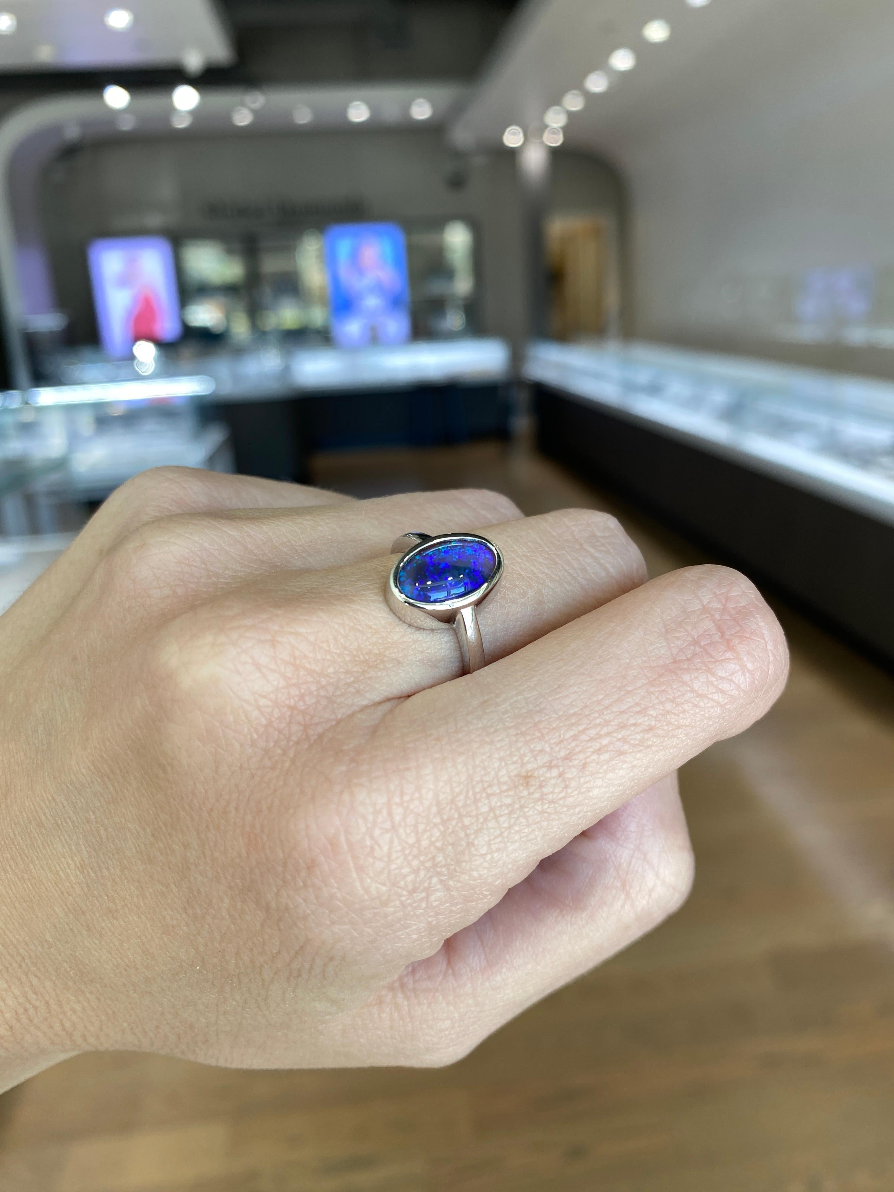 2.07 Carat Blue Oval Opal Bezel Set 18 Karat Gold Ring For Sale 2