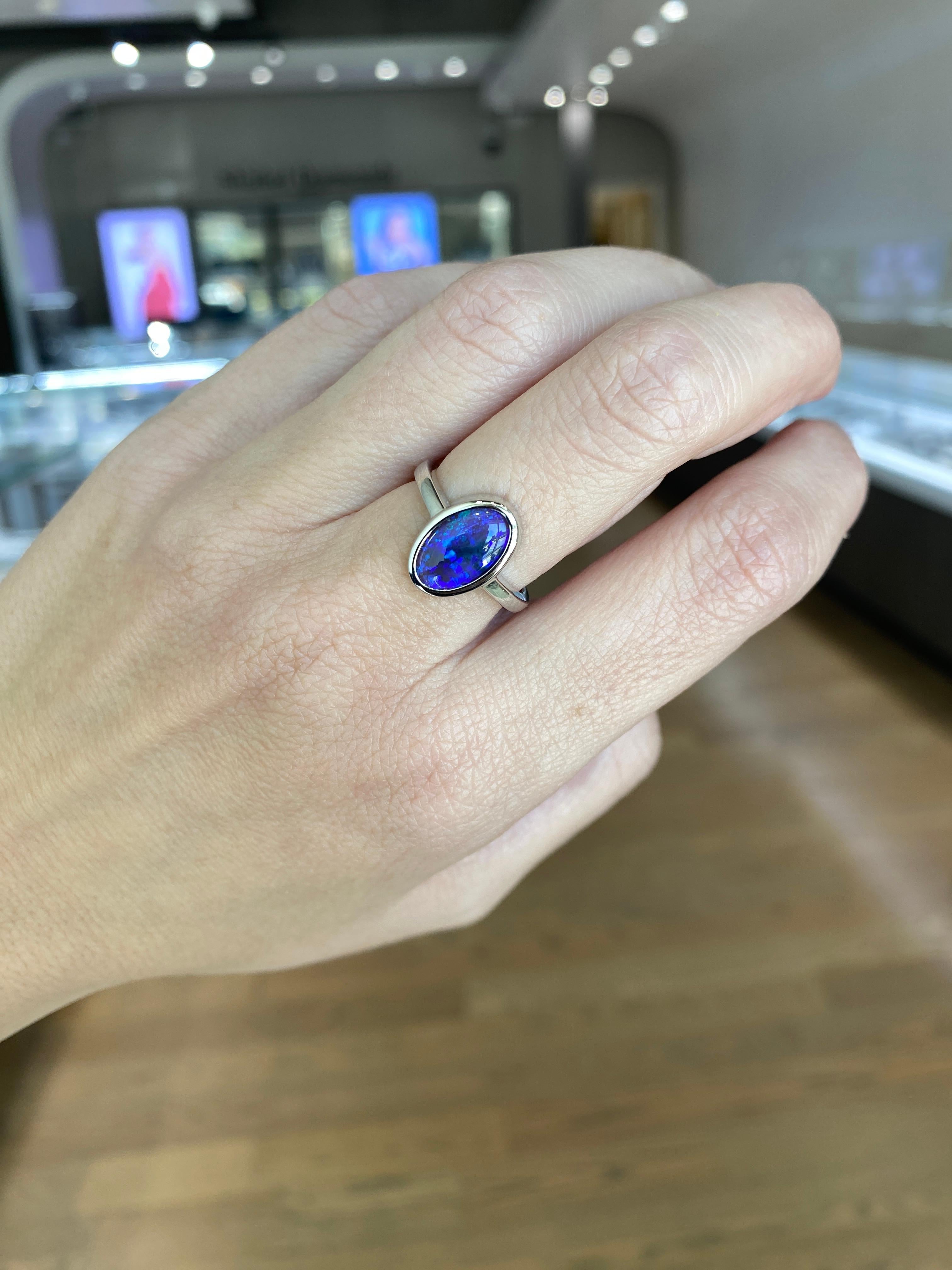 2.07 Carat Blue Oval Opal Bezel Set 18 Karat Gold Ring For Sale 3