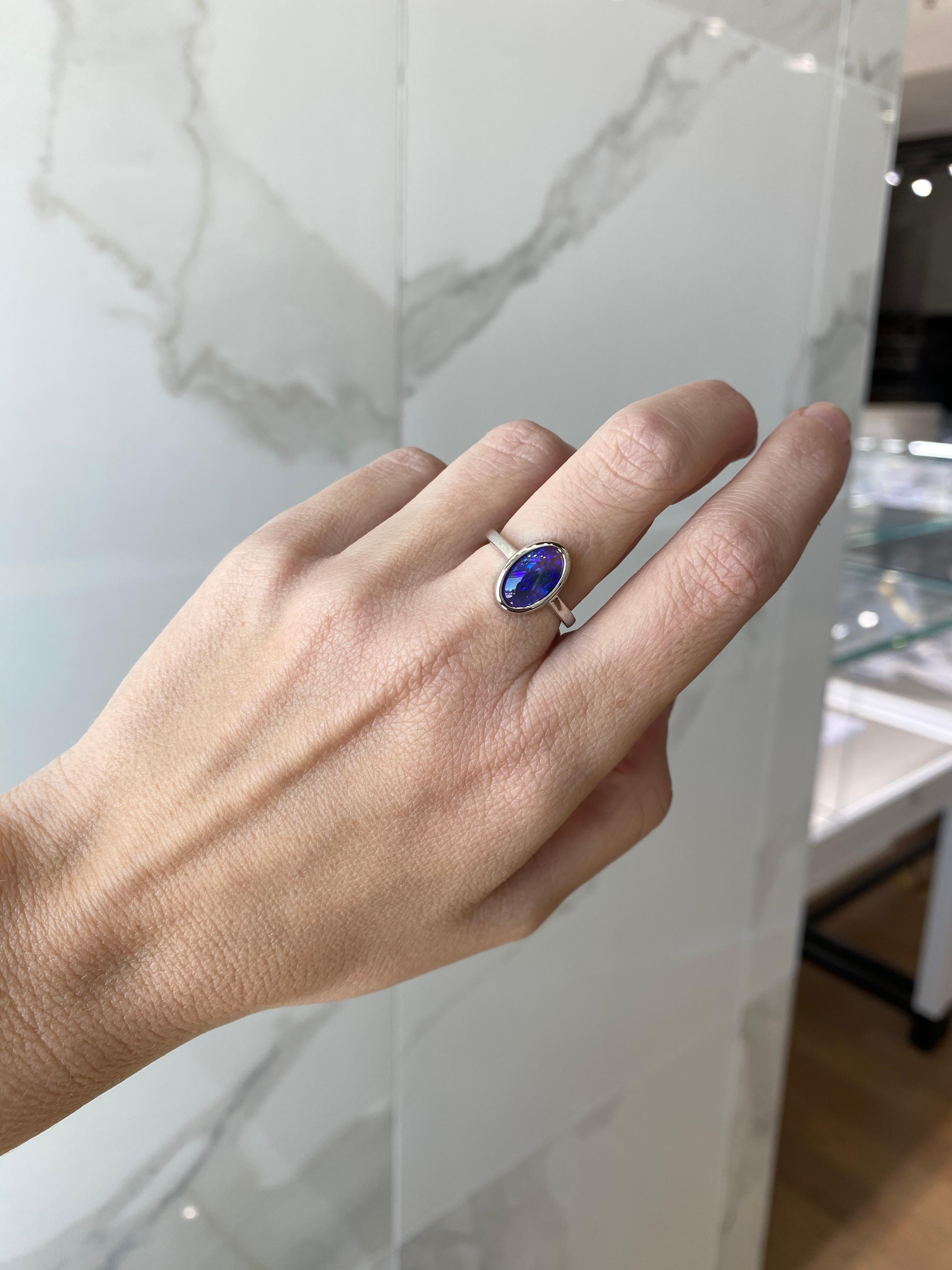 2.07 Carat Blue Oval Opal Bezel Set 18 Karat Gold Ring For Sale 4