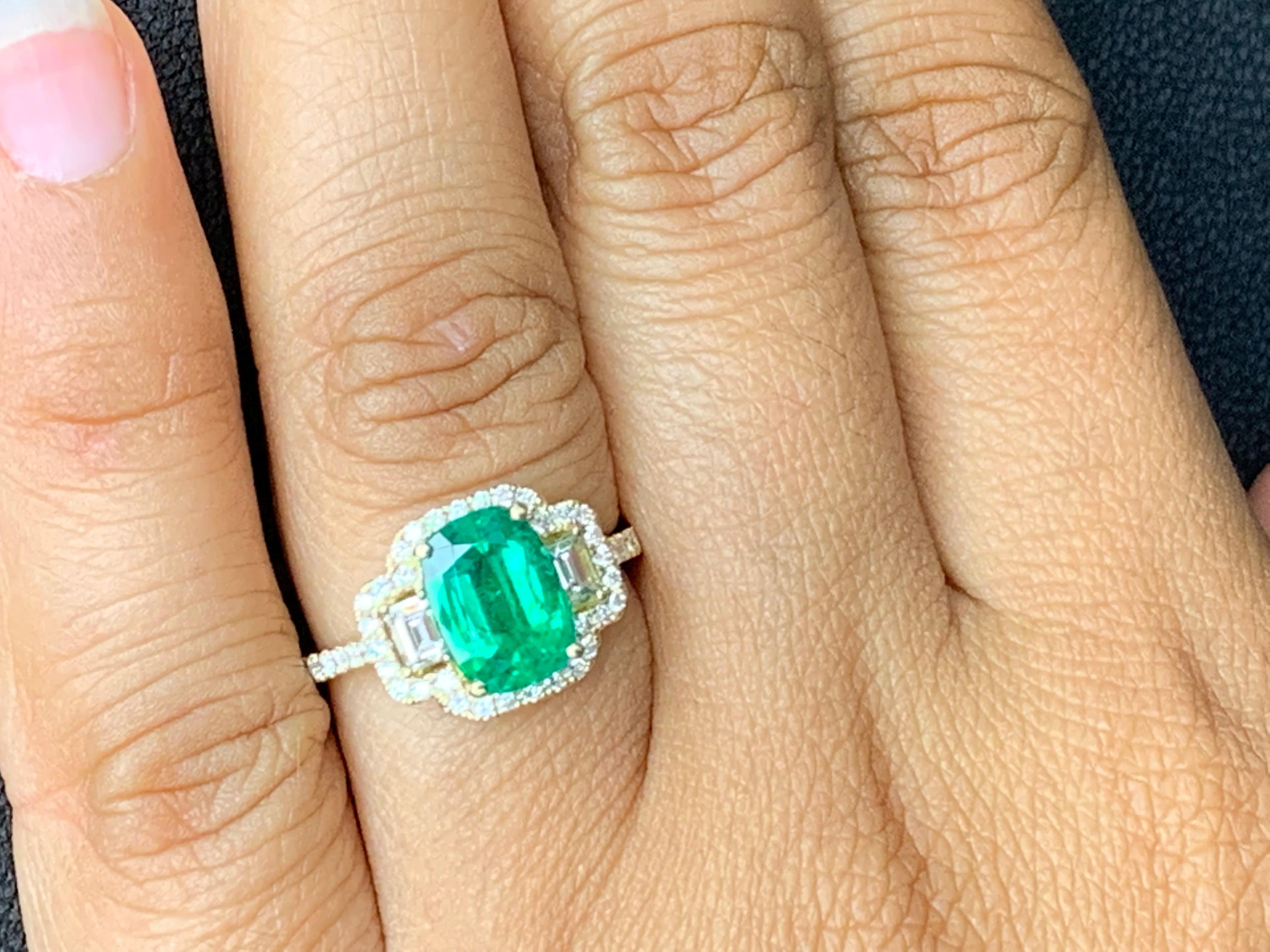 A unique handcrafted engagement ring showcasing a 2.07-carat cushion cut emerald. Flanking the center stone are two baguette white diamonds weighing 0.29 carat surrounded by a row of 48 brilliant-cut round diamonds set in a mounting made in 18K