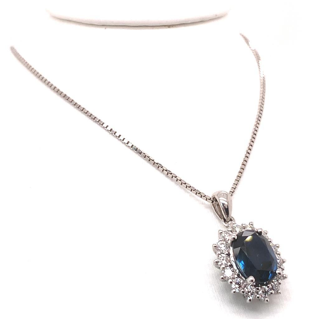 Glistening from every angle, this elegant pendant features an oval Blue Sapphire weighing approximately 2.07 Carats surrounded by dazzling Diamonds weighing 0.48 Carats. The stones are set in 18K White Gold giving this pendant the perfect finish.