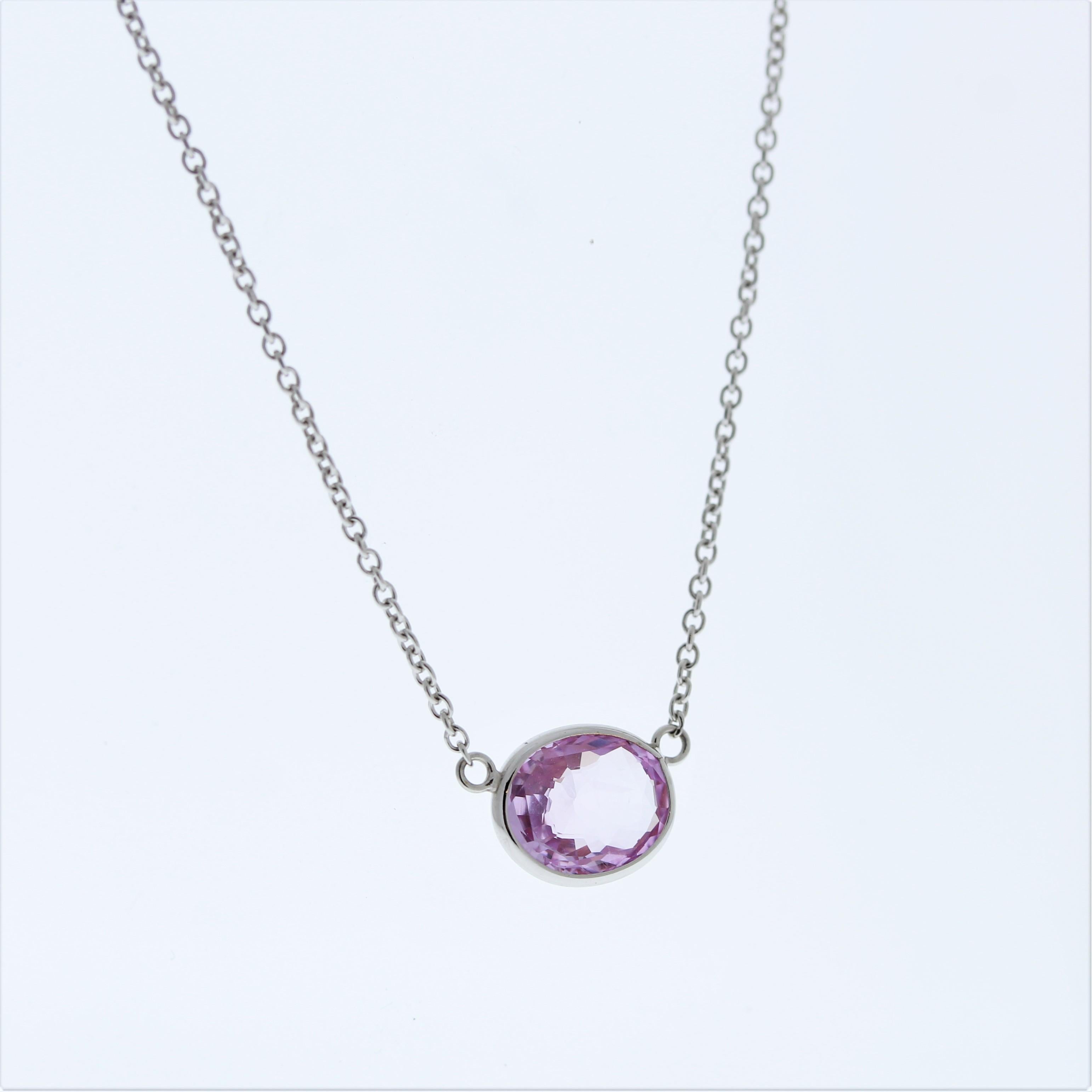 A necklace featuring a 2.07-carat padparadscha gemstone in an oval shape with a purplish pink hue set in 14k white gold would likely be a stunning and eye-catching piece of jewelry, perfect for adding a touch of elegance and sophistication to any