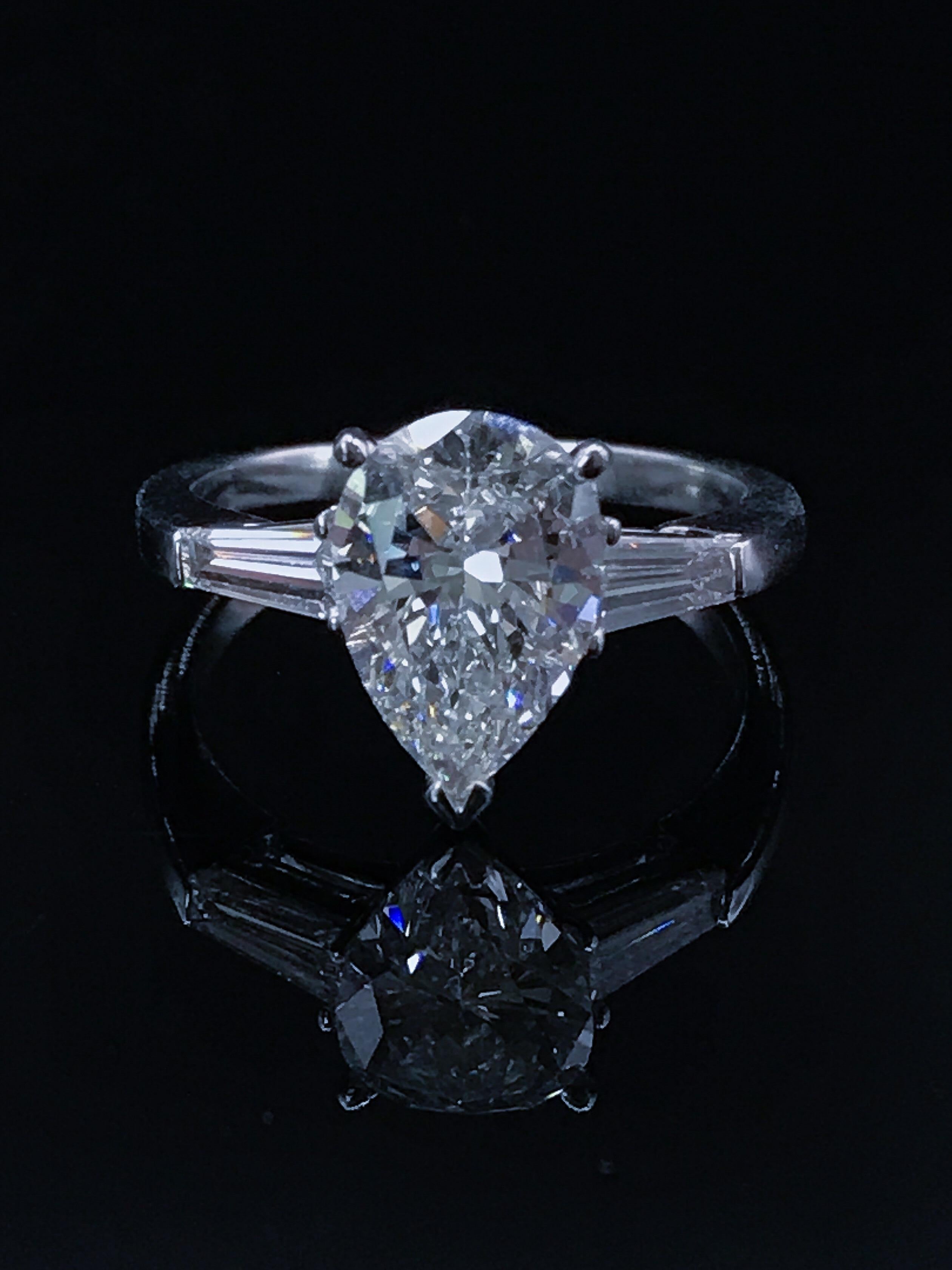 Custom Made 2.07ct Fine Quality Pear Shape G VVS2 GIA Platinum Diamond ring. Set with 0.43ct tapered baguette diamonds. Beautiful G color, vibrant, extremely clean. Custom made in Platinum with one of the finest jewelers.
GIA Certified center stone
