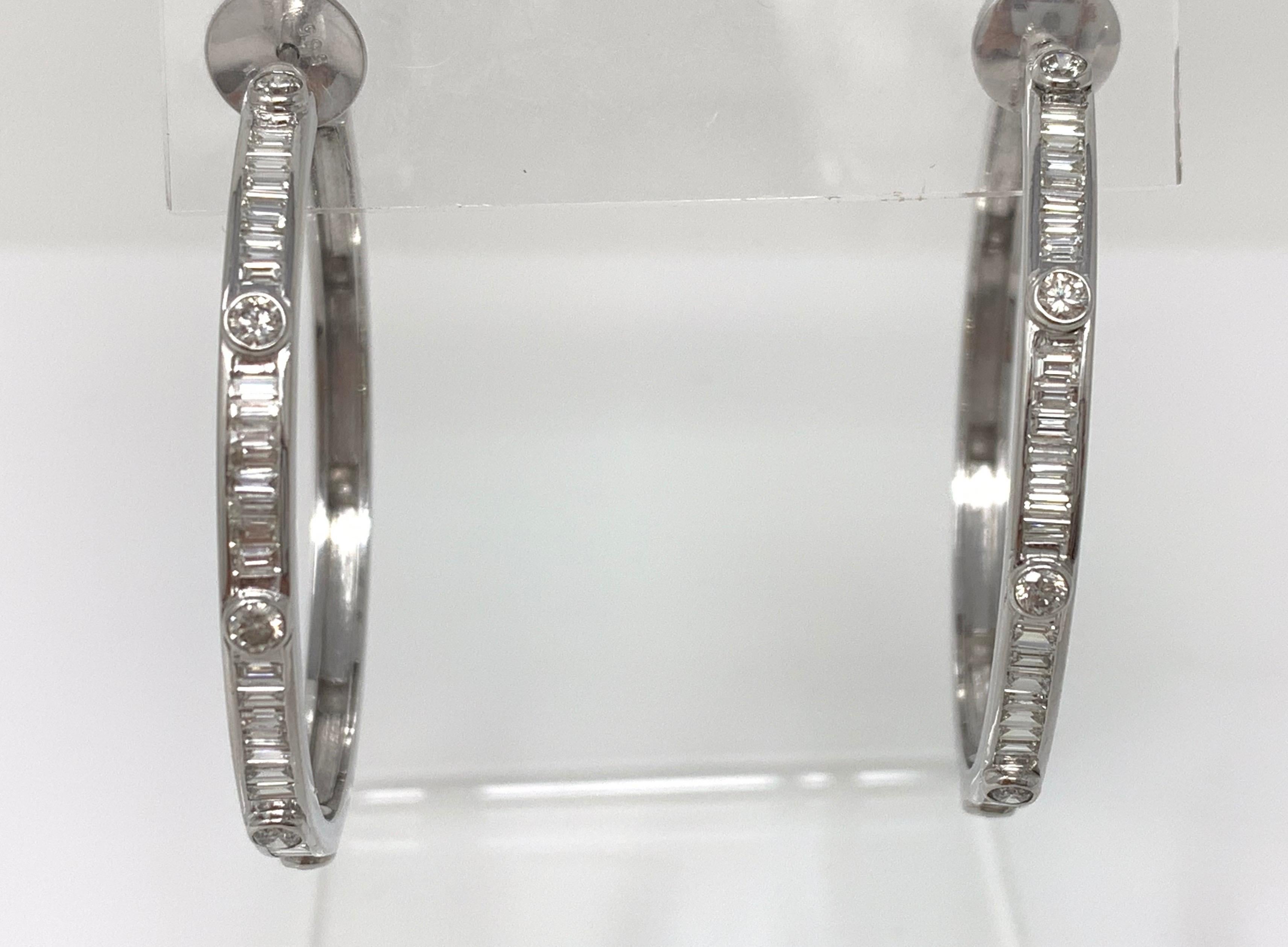 Classic and elegant white round brilliant diamond hoop earrings. These Moguldiam Inc hoop earrings are hand crafted in 18k white gold. The diamond weight is 2.07 carat and gold weight is 15.350 grams. 
The measurements are length = width = 1.5