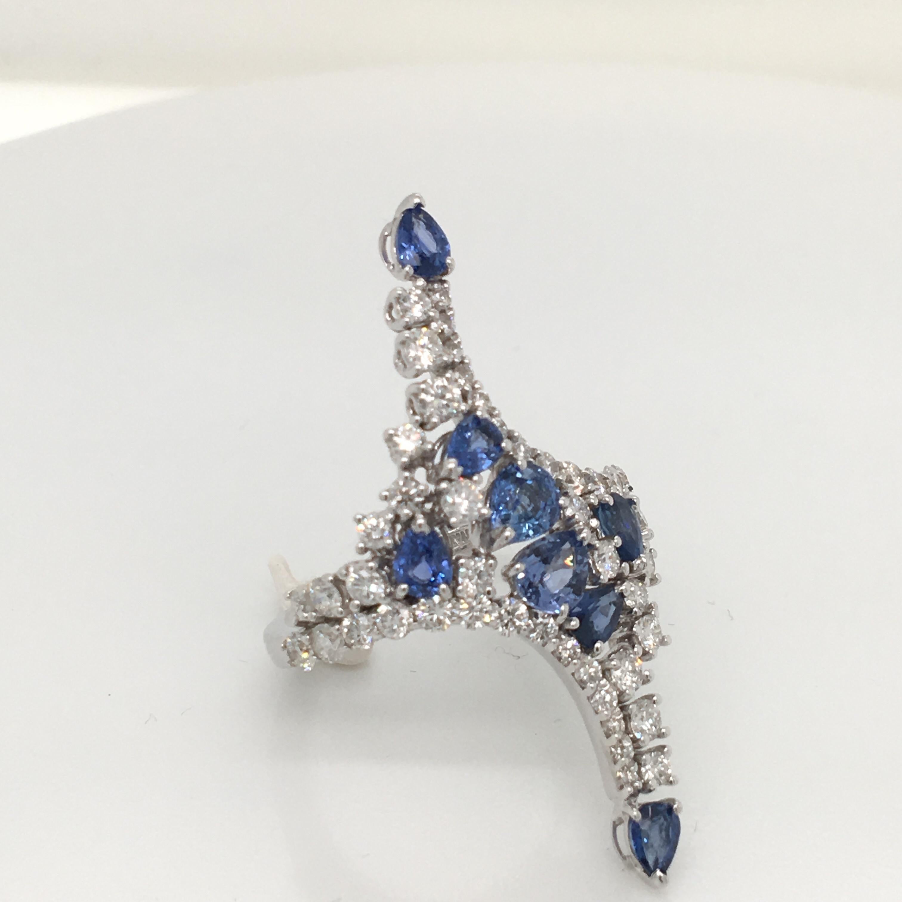 18 KT white gold  ring set with 2.07 carats  oval and pear shape cut blue sapphire and 1.53 carats of round cut diamonds color G clarity VS
made in Italy comes in a Box
finger size 15 italian size