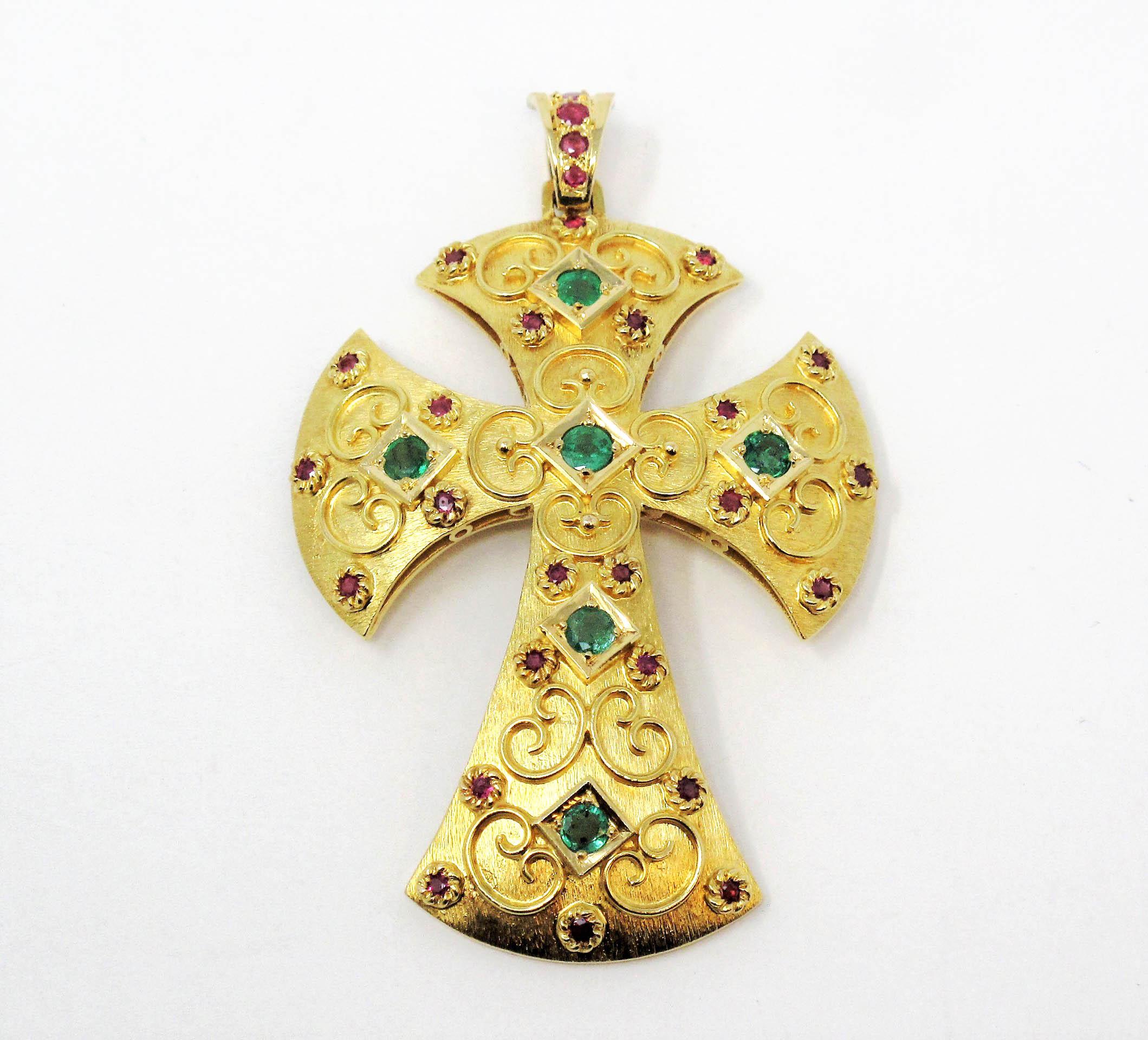 This incredible Etruscan style cross pendant is an absolute work of art. The subtly textured matte gold finish, paired with the vivid gemstones and intricate swirl design makes this ornate piece a stunning addition to your collection. 

This