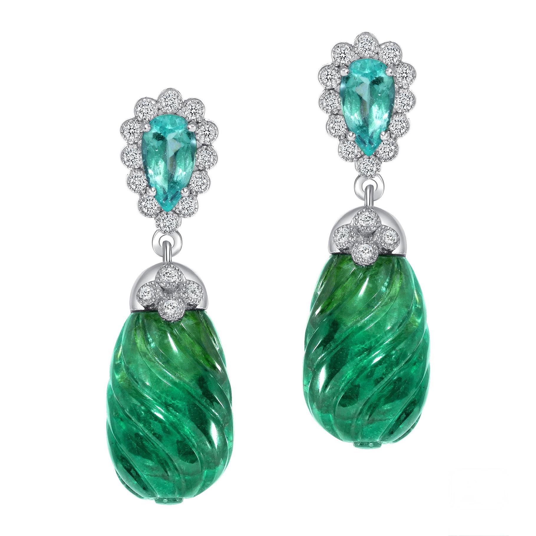 Two carved Zambian Emeralds weighing 20.77 carats are accompanied by two Paraiba-type Mozambique tourmalines totaling 0.71 carats. Each earring glows beautifully and are just mesmerizing together with icy white diamonds weighing a total of 0.40