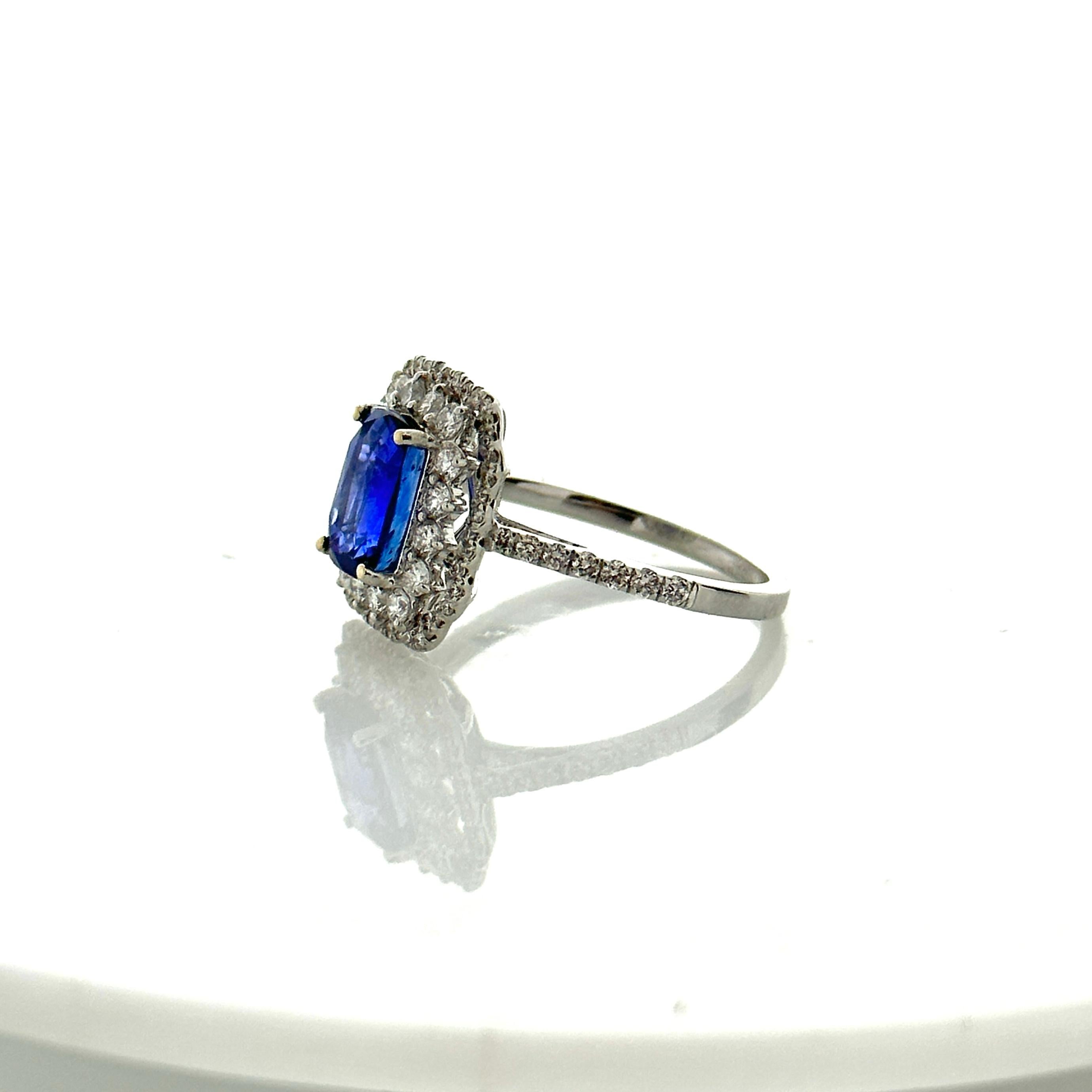 This is a 2.07 carats royal blue sapphire that is surrounded by a stunning halo of round brilliant diamonds. The sapphire is from Sri Lanka. The color is royal blue; its luster, clarity, and transparency are exceptional. The 0.73 carat total weight