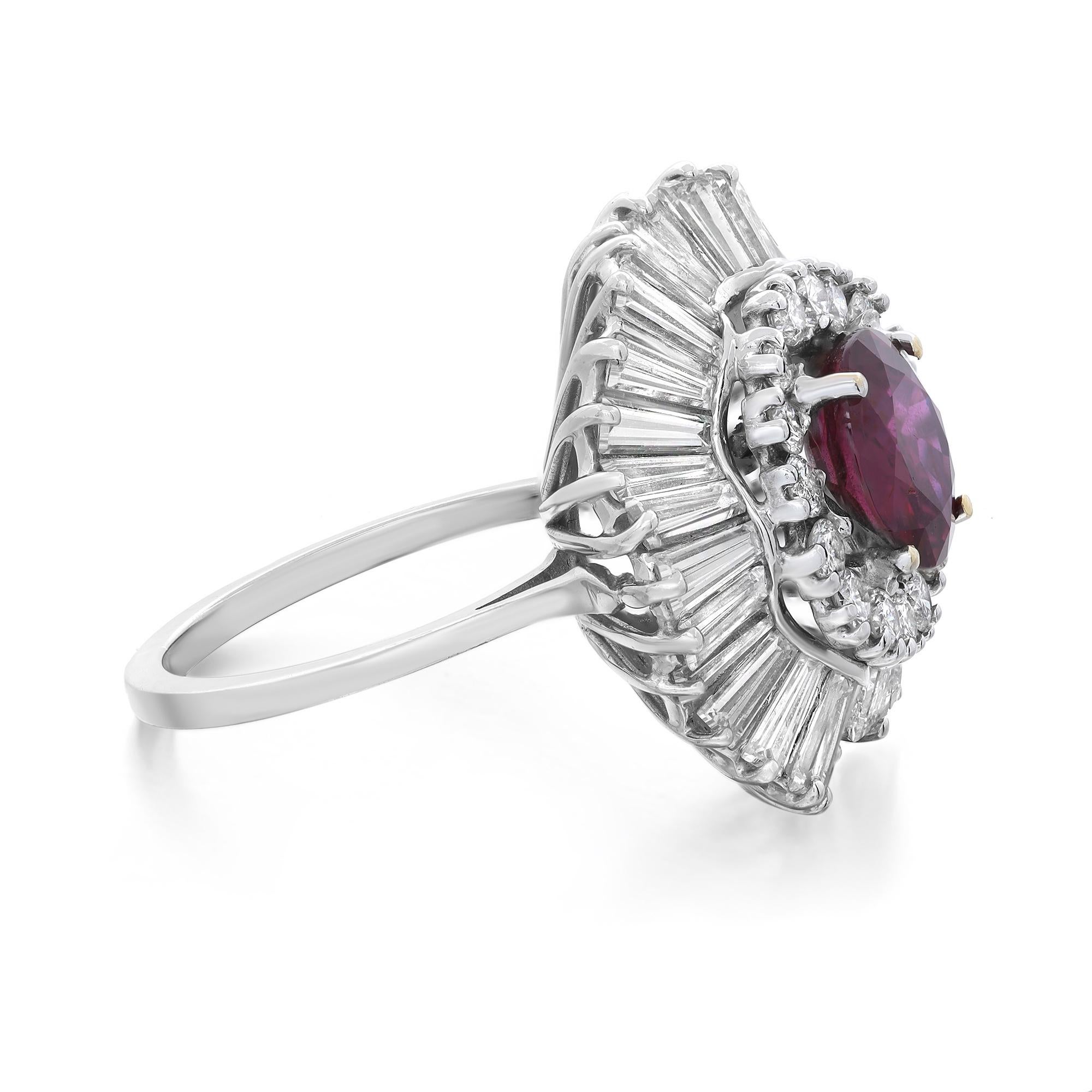 This gorgeous cocktail ring is crafted in 18k white gold. The center prong set round shape ruby weighing 2.07 carats is illuminated by a sparkling halo of round cut and baguette cut diamonds weighing approx. 3.00 carats. Diamond quality: color F-G