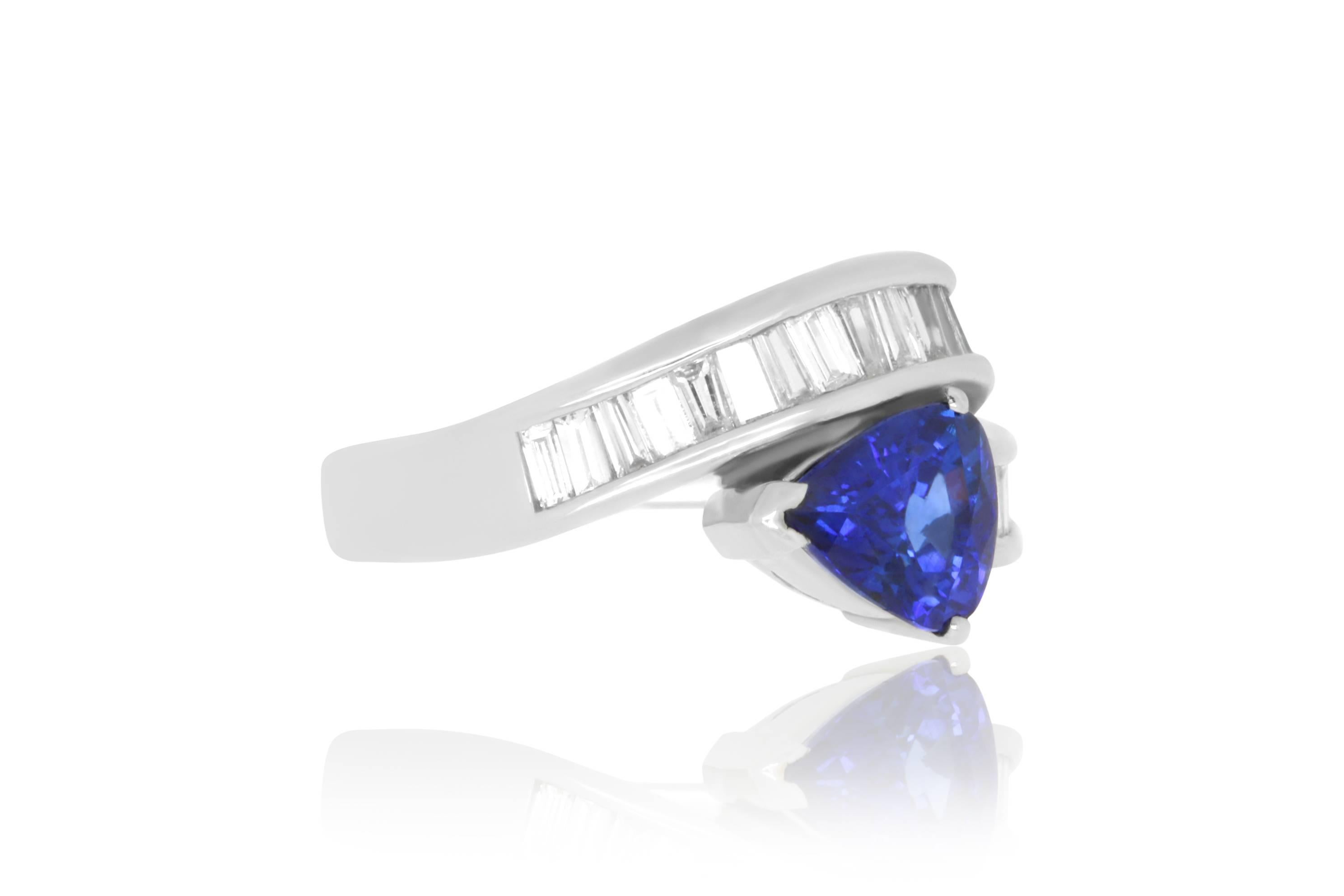 Material: Platinum 
Center Stone Details:  2.08 Carat Pear Shaped Blue Sapphire
Mounting Diamond Details: 25 Baguette White Diamonds Approximately 0.82 Carats - Clarity: SI / Color: H-I
Ring Size: Size 6.5 (can be sized)

Fine one-of-a kind