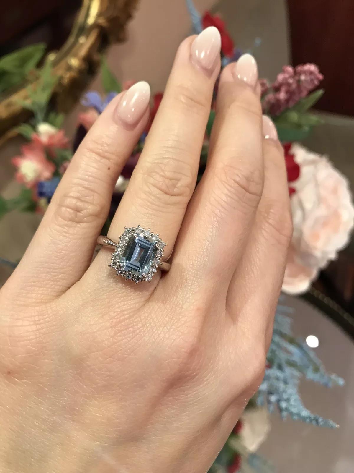 2.08 carat Emerald Cut Aquamarine and Diamond Halo Ring in Platinum

Aquamarine and Diamond Ring features a very clean, light blue Emerald-cut Aquamarine surrounded by Round Brilliant Diamonds set in a Platinum setting.

Total aquamarine weight is