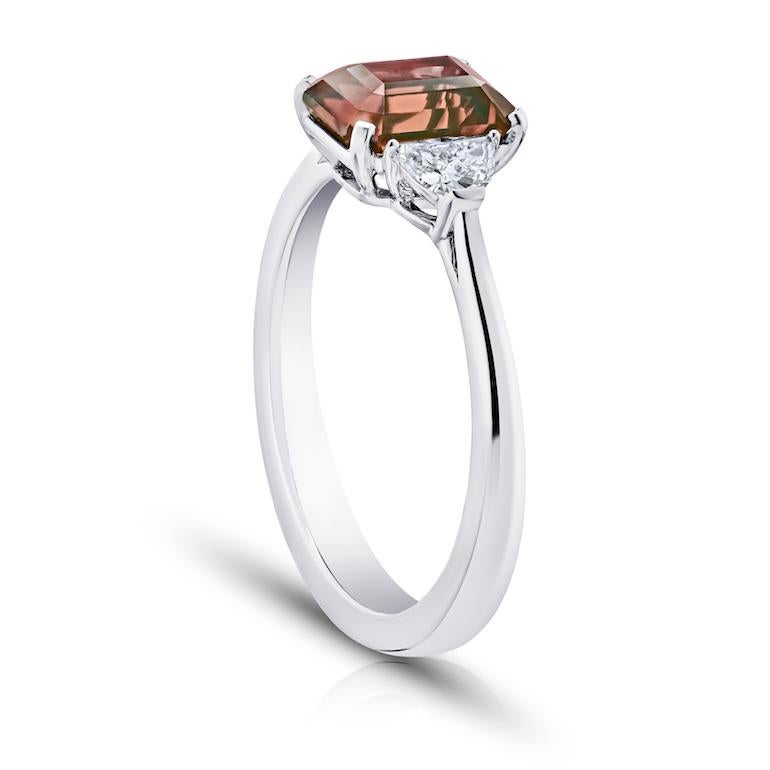 2.08 carat emerald cut (natural no heat) reddish brown sapphire with half moon shaped diamonds .29 carats set in a platinum ring.
