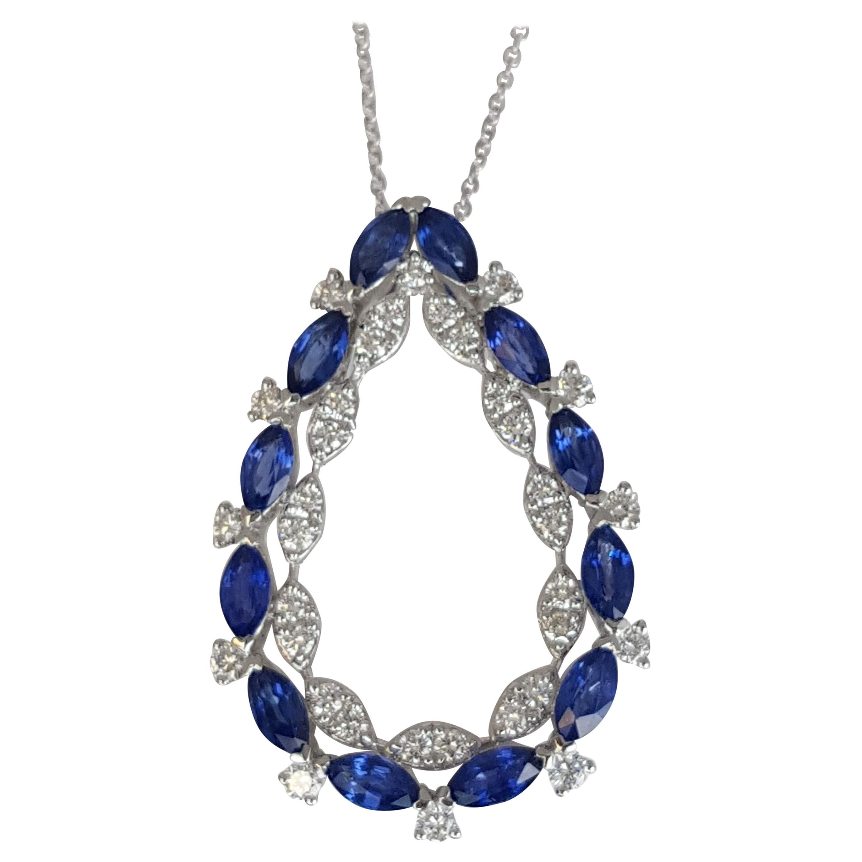 At the outside of this pendant, 12 marquise-cut blue sapphires playfully alternate with 11 round diamonds, creating a captivating dance of color and sparkle. The sapphires symbolize wisdom and royalty, while the diamonds represent purity and
