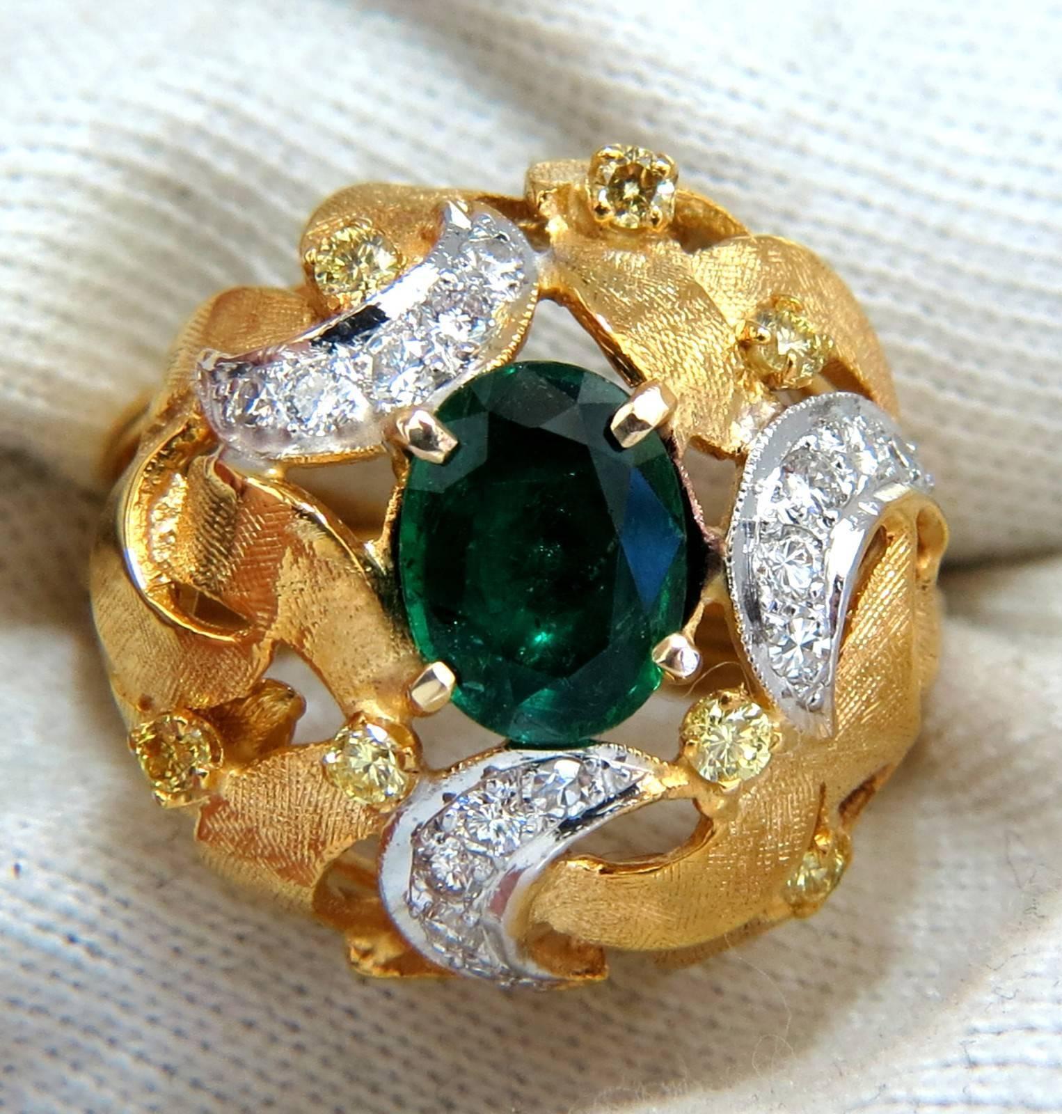 European Florentine Interwined

1.35ct. Natural Emerald Ring

9 X 7mm

Transparent & Vivid Green 

.28ct. natural yellow Diamonds.

.45ct. white diamonds.

Round & full cuts 

G-color Vs-2 clarity.  

14kt. yellow gold

11.6 grams

Ring Current