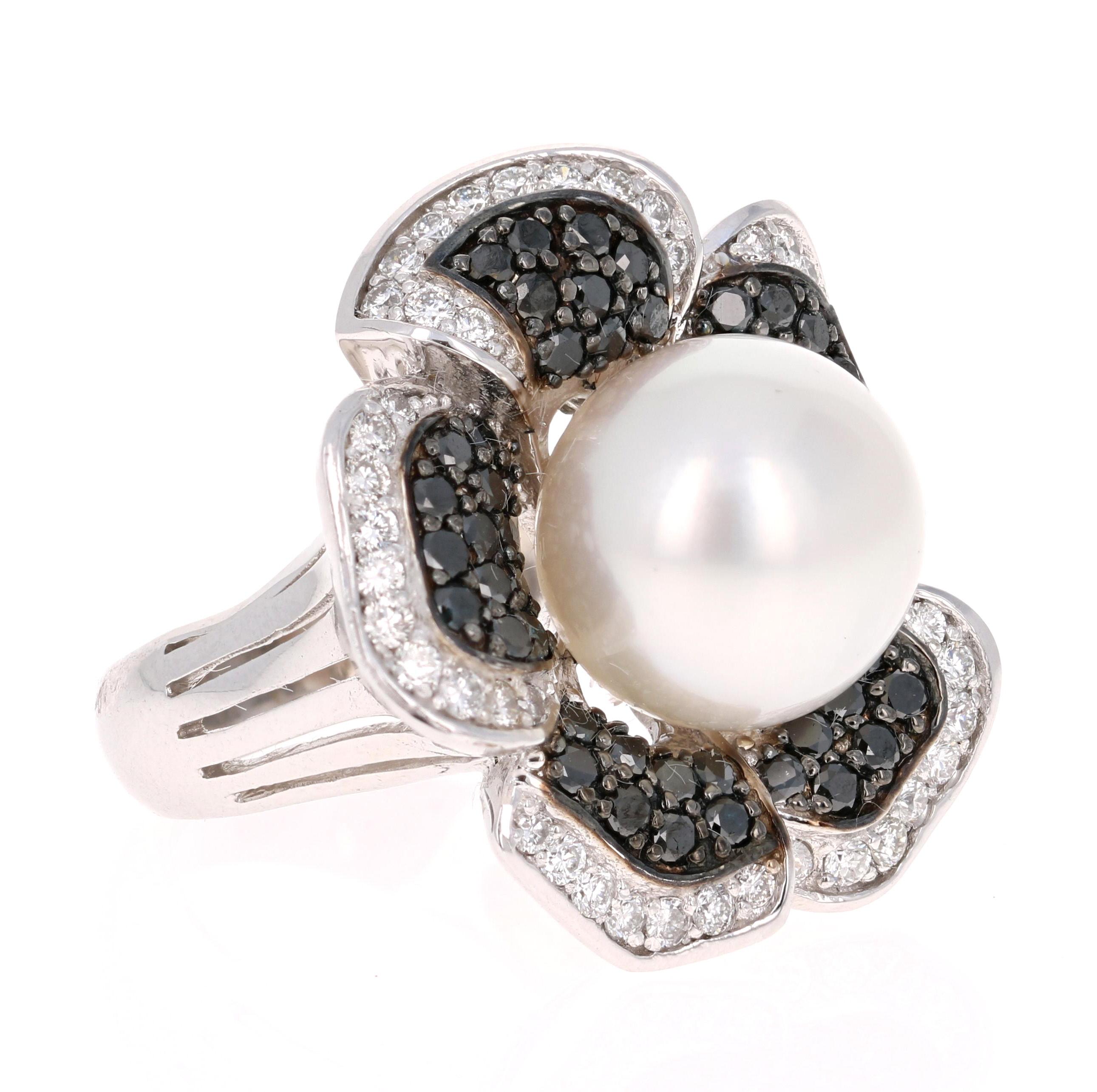 This beautiful flower like ring has a stunning South Sea Pearl that is set in the center of the ring.  The pearl is surrounded by a cluster of 49 Black Round Cut Diamonds that are set a petal like design.  The Black Diamonds weigh 1.26 carats, these