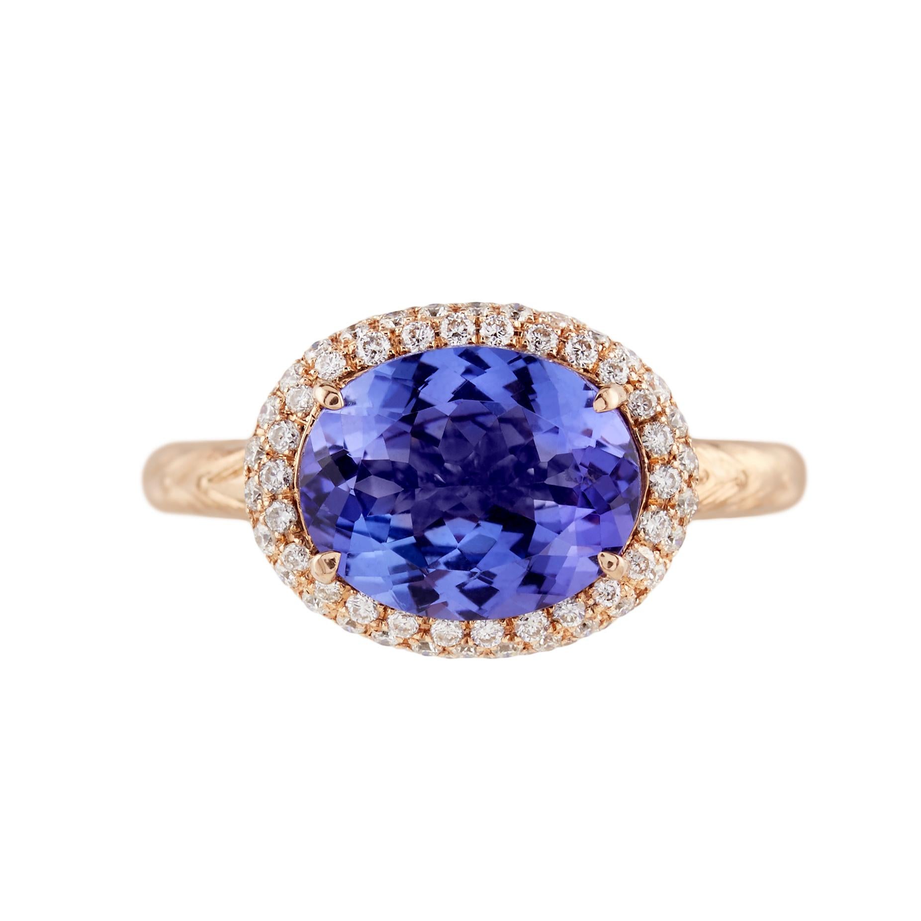 2.08ct Oval Tanzanite beautifully set sideways with a 0.50ct diamond halo ring with a hand engraved shank, 14K rose gold. 