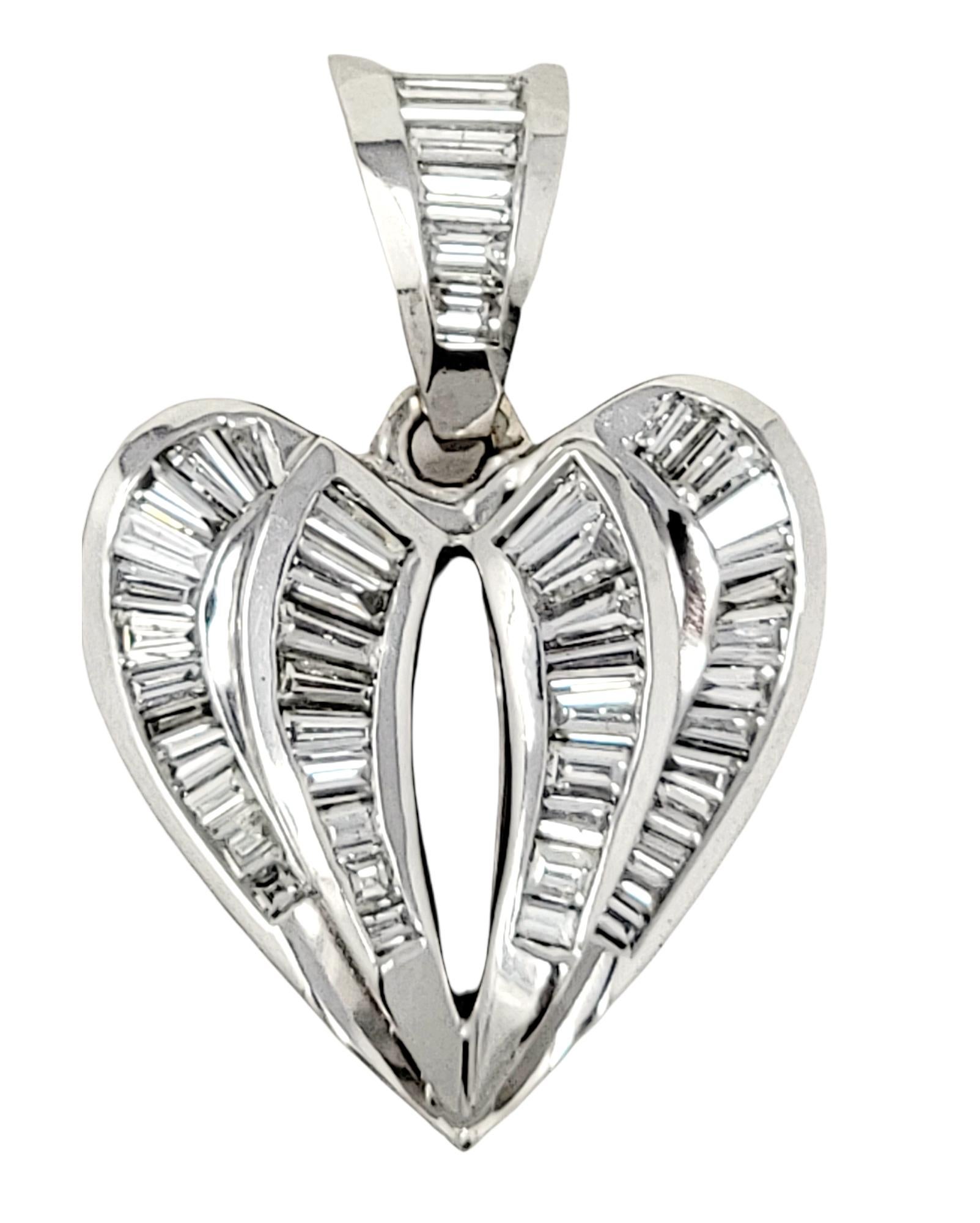 Gorgeous, glittering heart shaped pendant will absolutely light up her neck! The polished white gold paired with the icy white baguette and square diamonds, makes for a stunningly sparkly piece. The classic heart shape remains timeless, ensuring