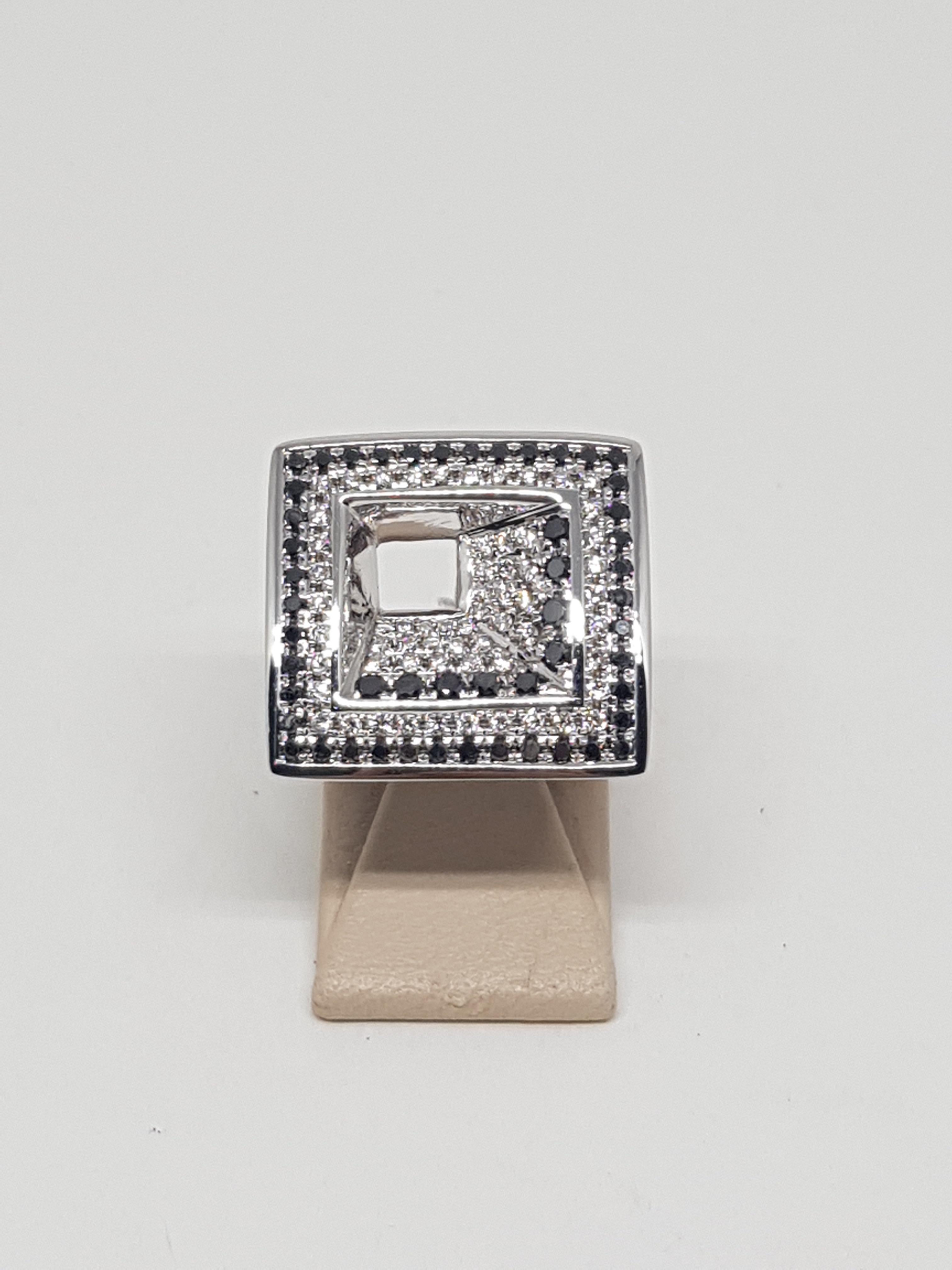 Gold: 18 carat white gold 
Weight: 16,18gr.
White Diamonds: 1,24 ct. colour: F clarity: VS ( 77 Diamonds )
Black Diamonds: 0,84 ( 53 Diamonds )
Width: 2,0 cm.
Ring size: 57 / 18,2mm Free Resizing
All our jewellery comes with a certificate and 5