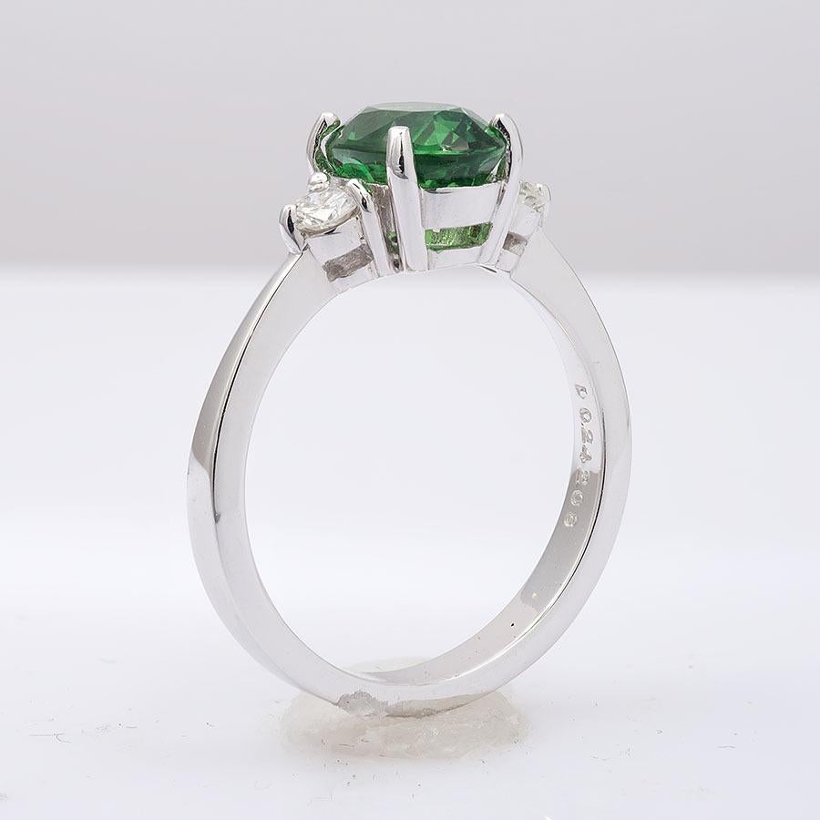 This eye clean 2.08 carat Tsavorite Garnet mined in Madagascar has been set in 18K white gold to make you look effortlessly elegant. Set with two beautifully matched diamond accents placed on either side highlighting the center stone, the ring is