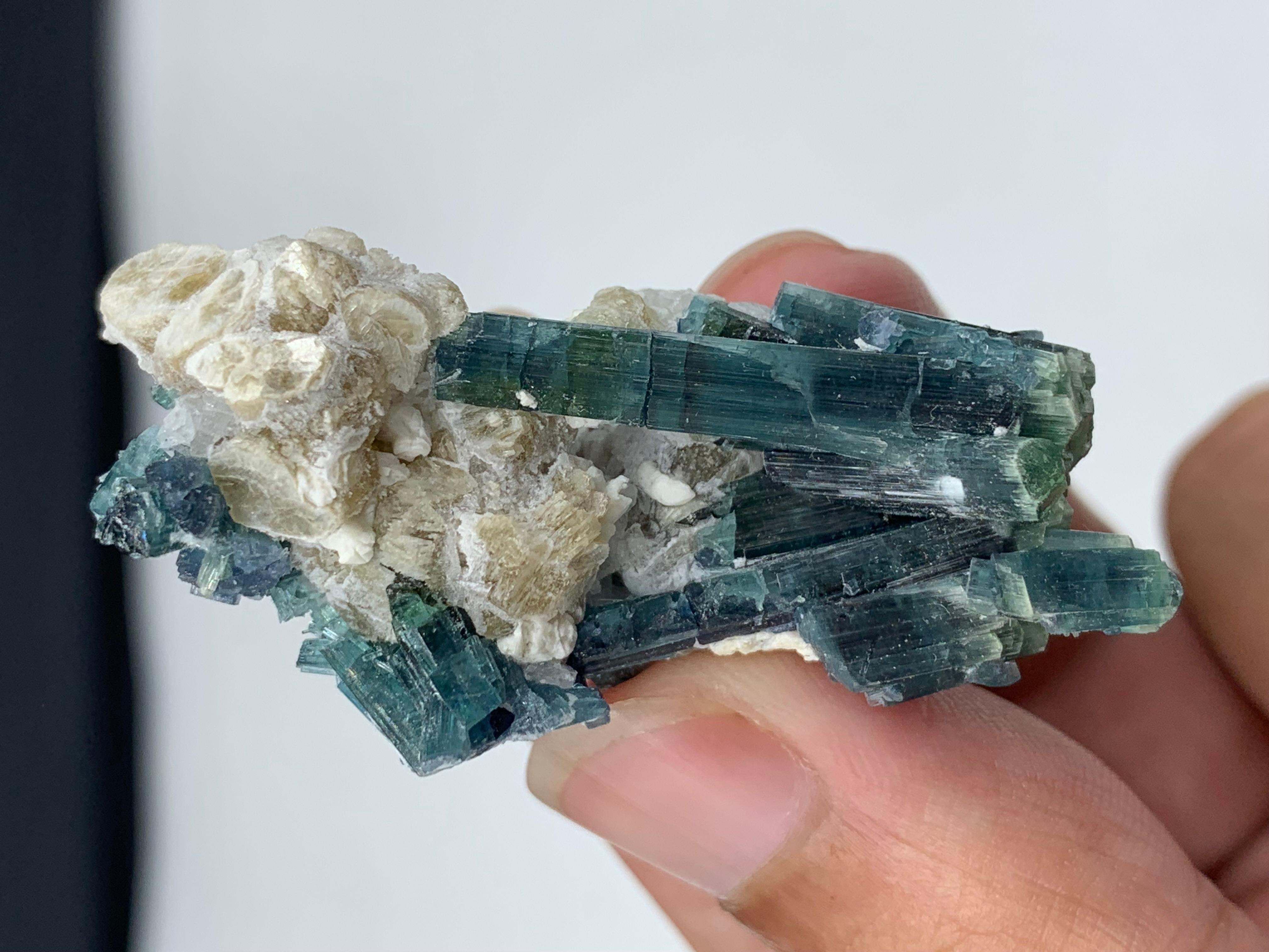 20.81 Gram Indicolite Blue Tourmaline Crystal With Albite From Afghanistan 
Weight: 20.81 gram
Dimension : 5 x 2.4 x 1.9 Cm 
Origin: Kunar, Afghanistan 

Tourmaline is a crystalline silicate mineral group in which boron is compounded with elements