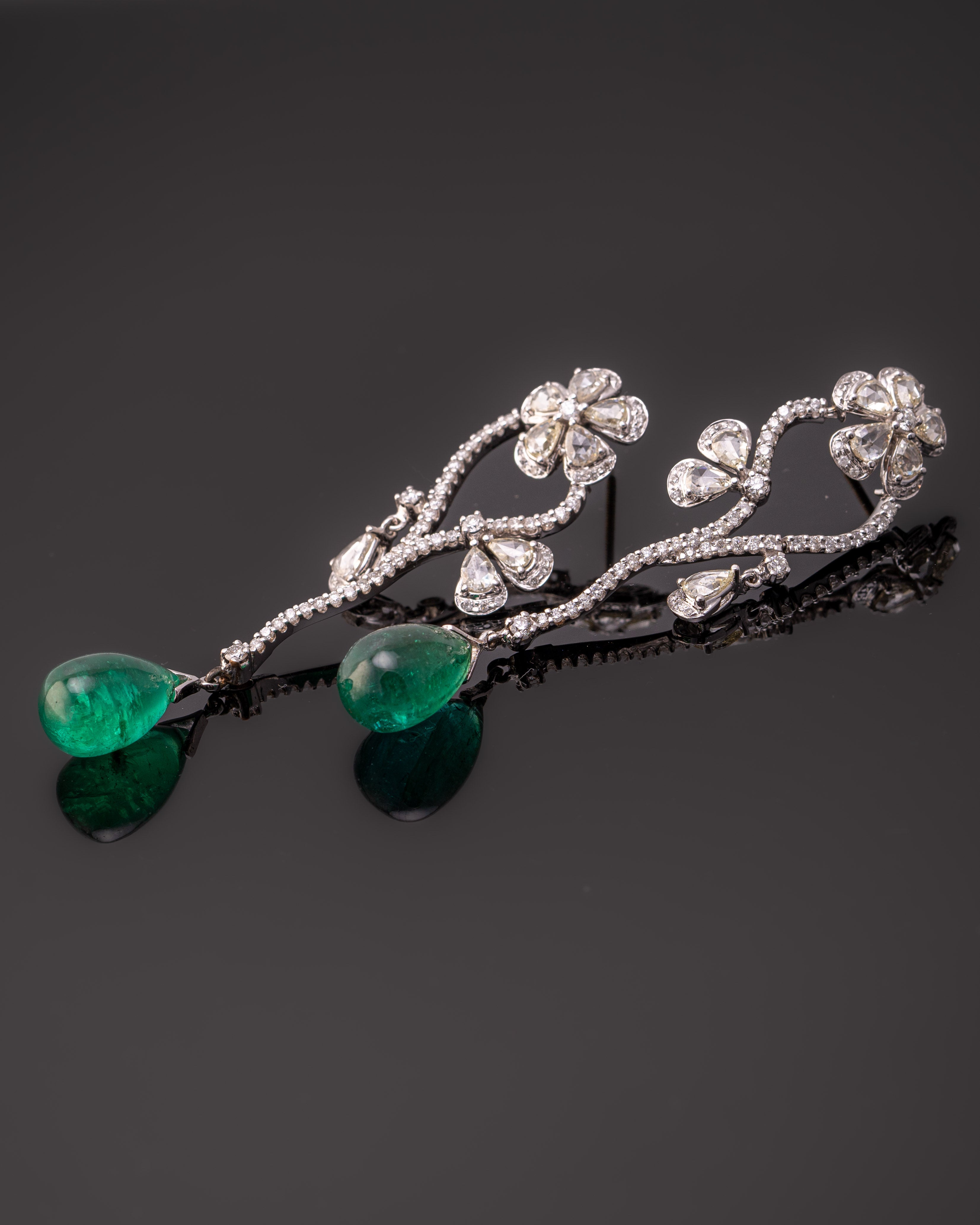 Make a statement with this stunning pair of 20.87 carat natural Zambian Emerald drop earrings, with 2.86 carat rose cut and 1.59 carat brilliant cut White Diamonds. The Emeralds are absolutely transparent, with a great vivid green color and luster.