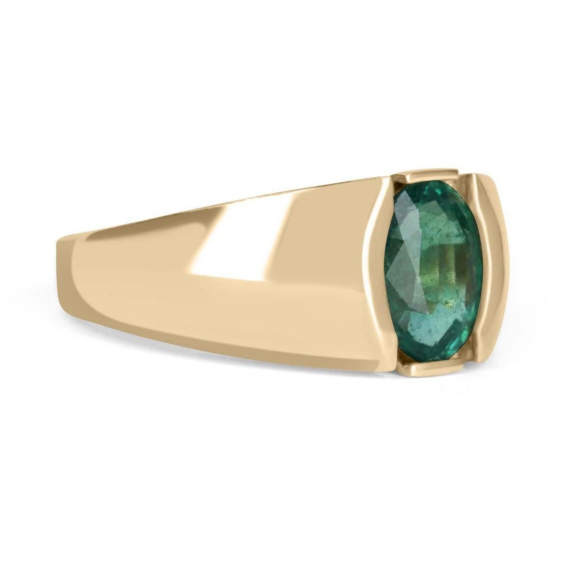 This is a simple and sophisticated unisex emerald ring. The emerald carries a full 2.08-carats and showcases a dark green color, with a bluish-green undertone. It is set in a simple and secure, 14k yellow gold tension setting. The perfect