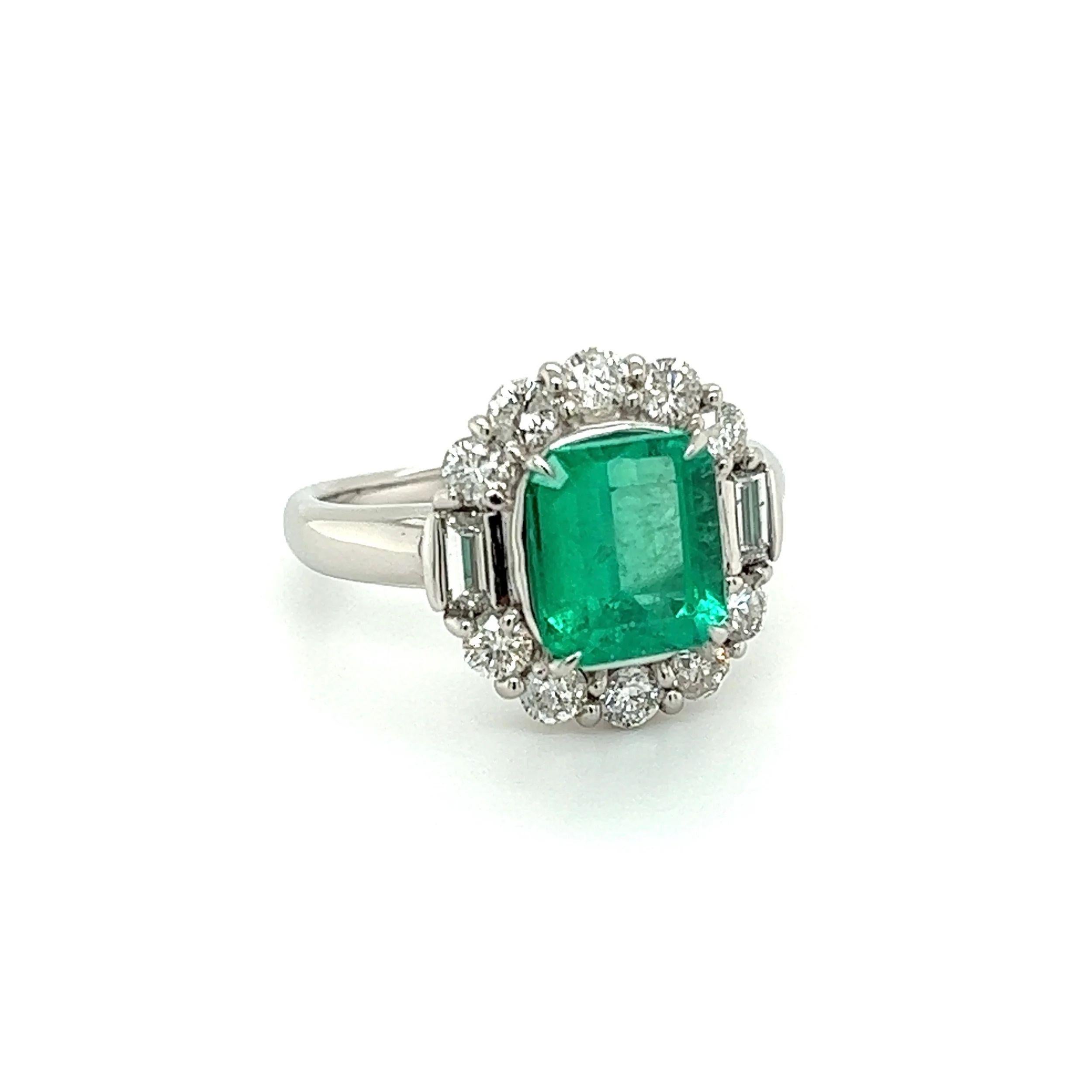 Simply Beautiful! Finely detailed Emerald and Diamond Platinum Cocktail Ring. Centering a securely nestled 2.09 Carat Emerald Cut Colombian Emerald. Surrounded by Baguette and Round Diamonds, weighing approx. 0.90tcw. Hand crafted in Platinum. Ring