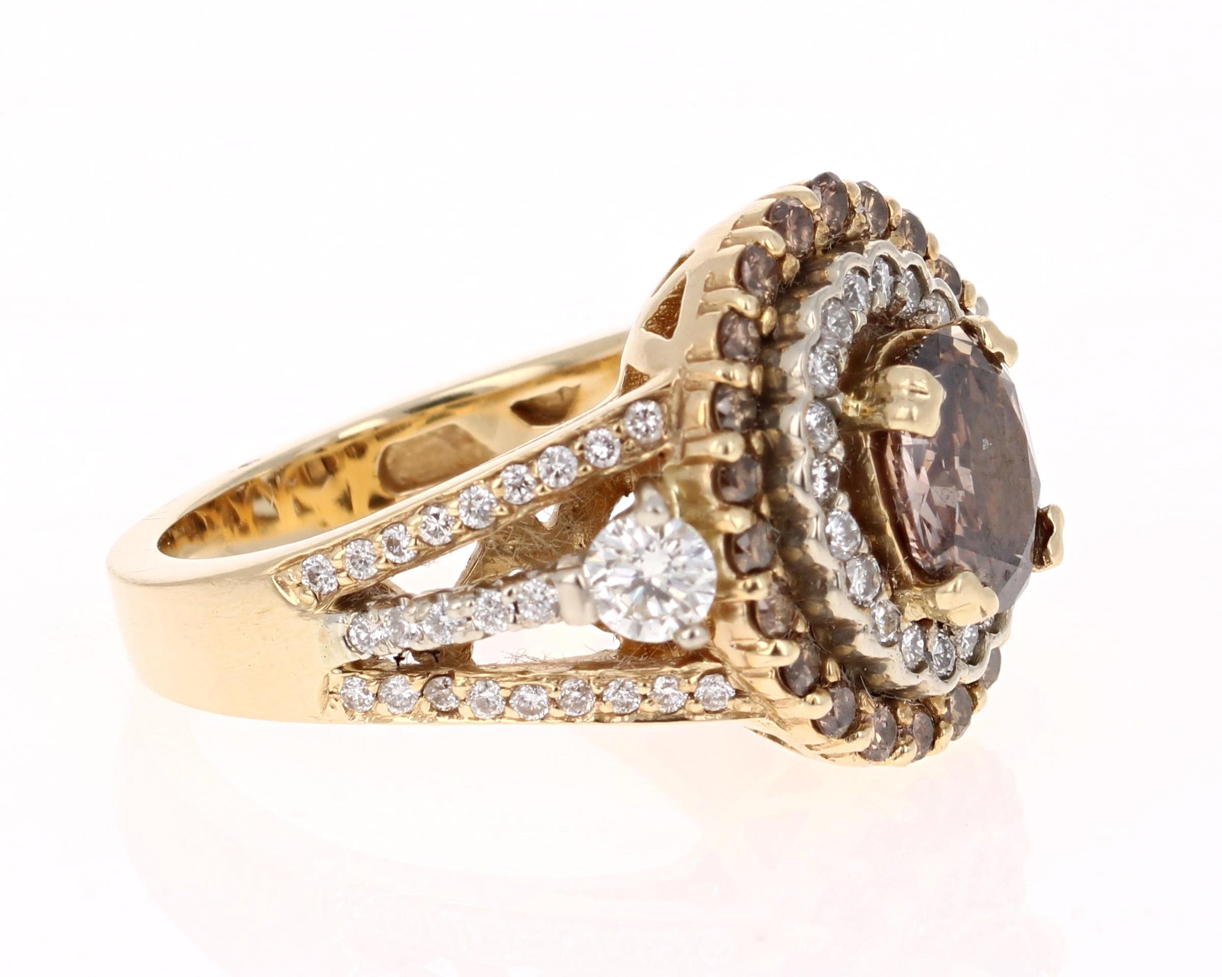 This beauty has a deep Brown/Champagne colored natural Oval Cut Diamond that weighs 1.03 Carats. It is surrounded by 46 Round Cut Diamonds that weigh 0.43 Carats. The clarity and color of the diamonds are VS-I. There are also 22 Brown Round Cut