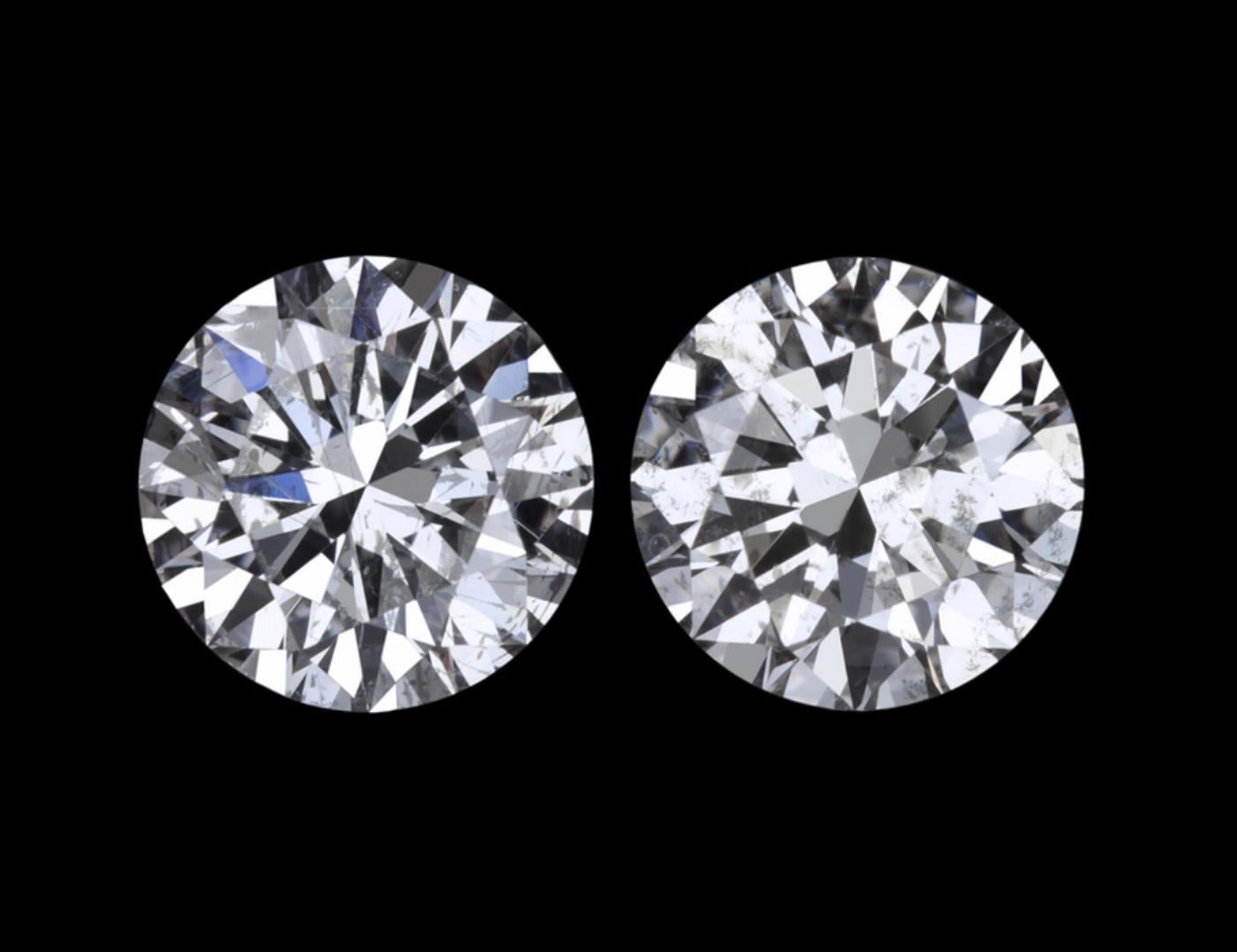 This amazing  2.09 carat matched pair of round brilliant cut natural diamonds are eye clean, brilliantly white, and have dazzling sparkle! Measuring 6.5mm in diameter, the diamonds have great spreads and a larger than typical look for their weight.