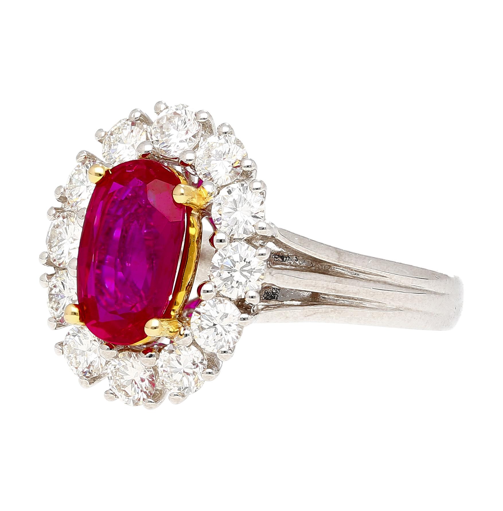 2.09 carat oval cut no heat ruby and diamond halo ring. Adorned with 12 round cut diamonds forming a halo, totaling 1.08 carat. The ruby is prong set in 18k yellow gold and the rest of the ring is crafted in platinum 900. The ring weights 8.81 grams