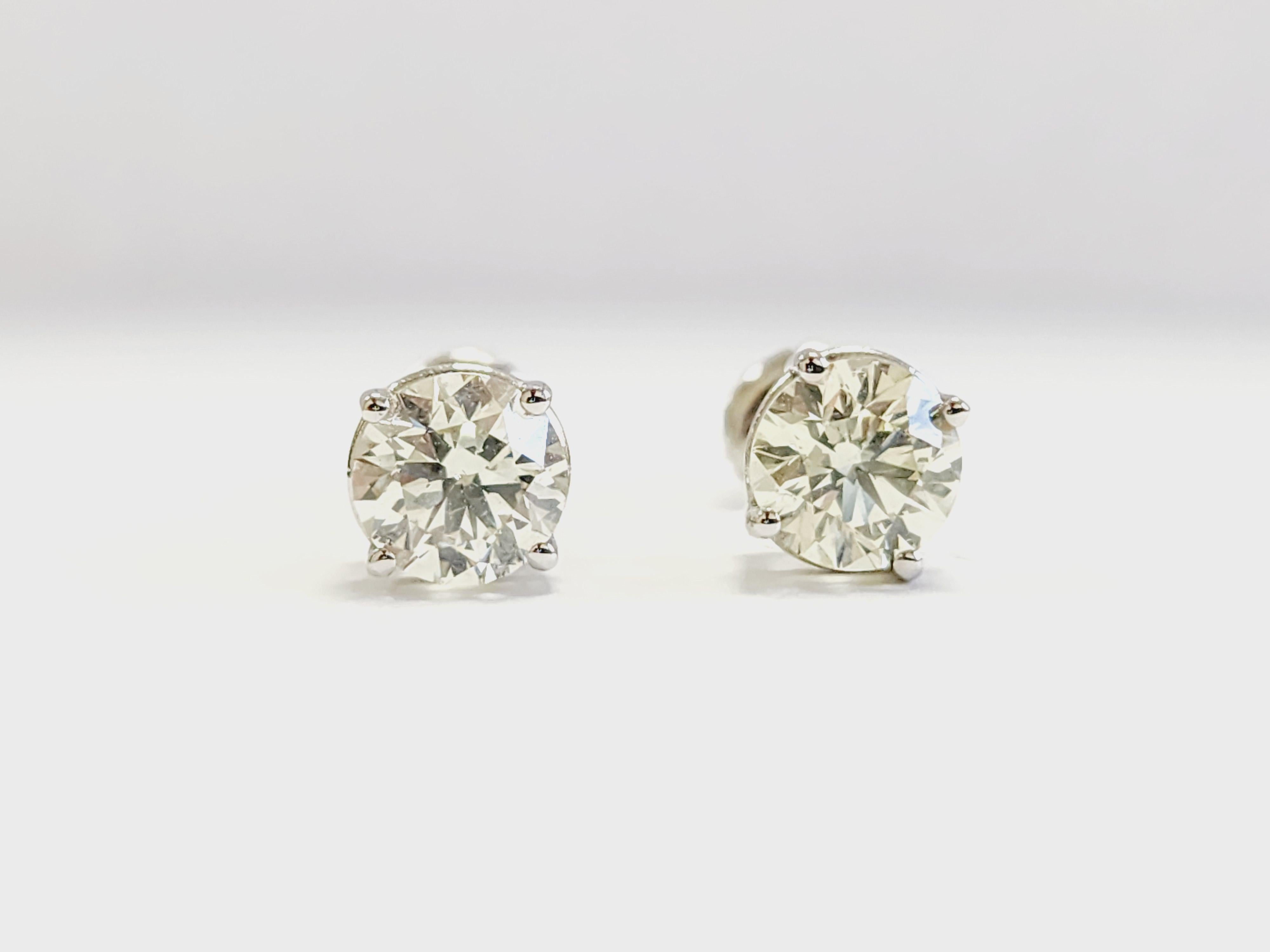 2.09 Carat Pair of Natural Brilliant Diamond Round Studs White Gold 14 Karat

Setting: 4 prong screw back 
Gold: 14k white gold 
Total carat weight: 2.09 Carats
Average Color: I-J
Average Clarity: VS1